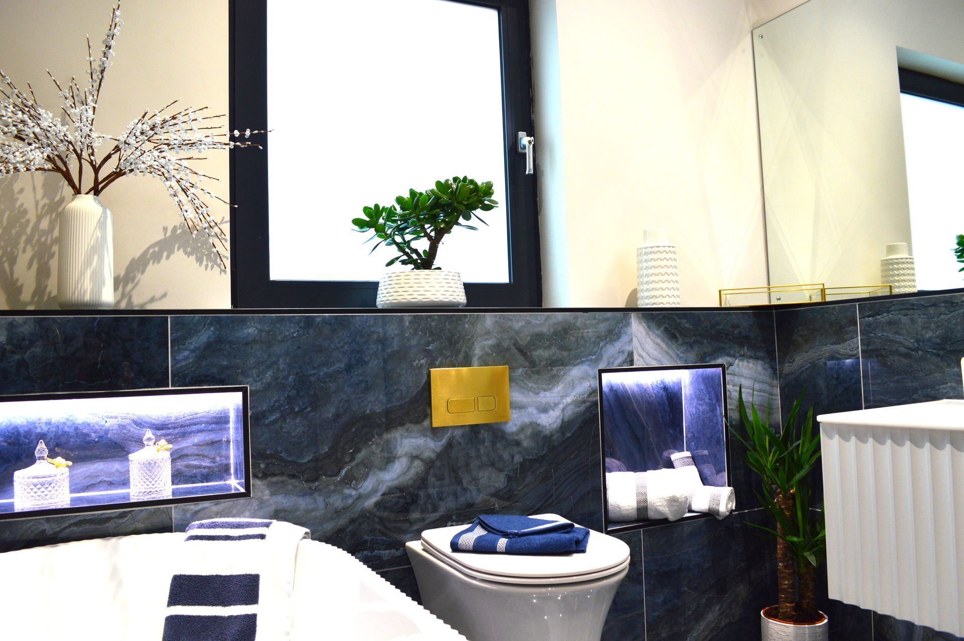 A bathroom with a toilet a sink and a window