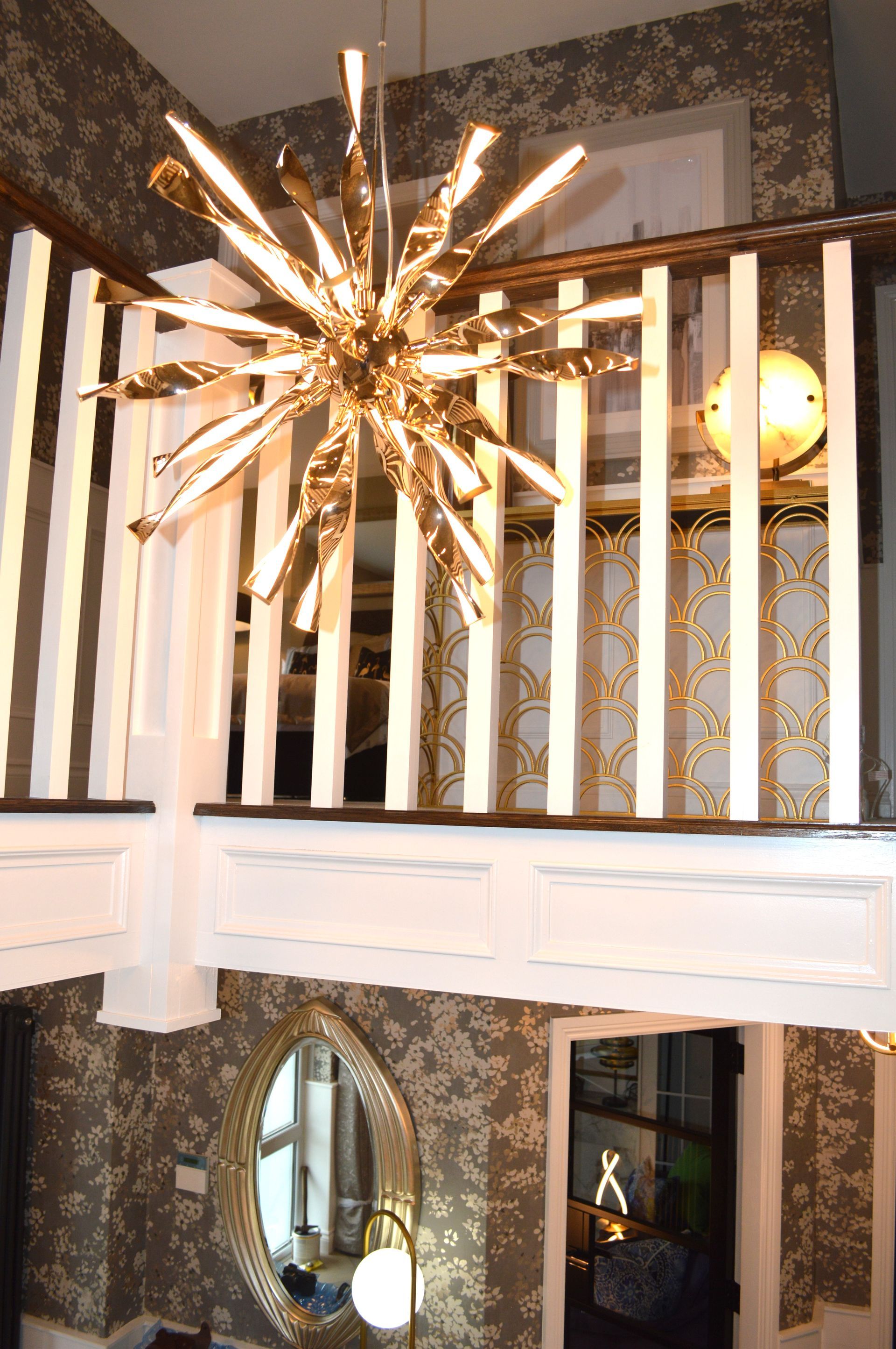 A staircase with a chandelier hanging from the ceiling