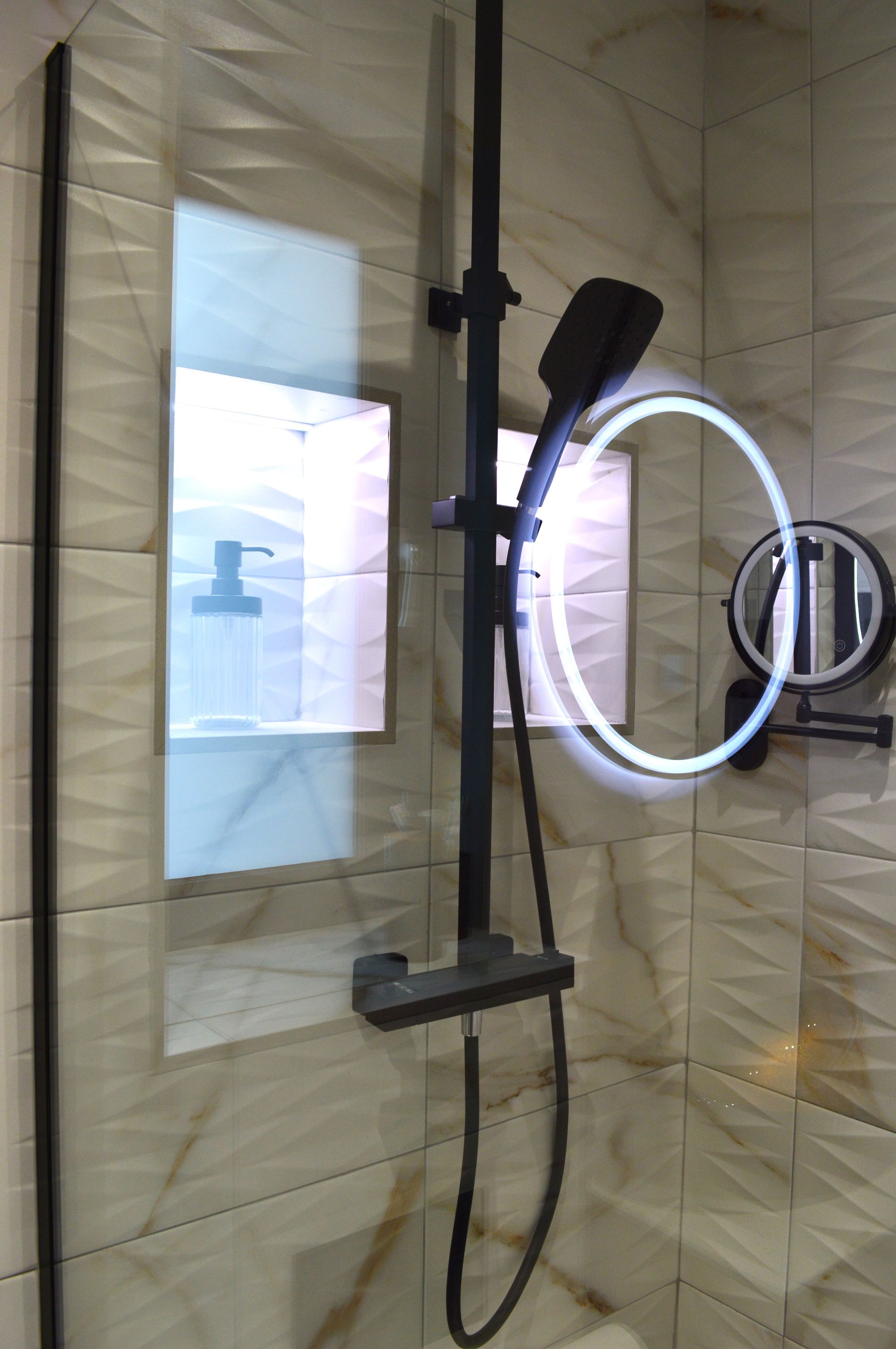 A bathroom with a shower head and a mirror.