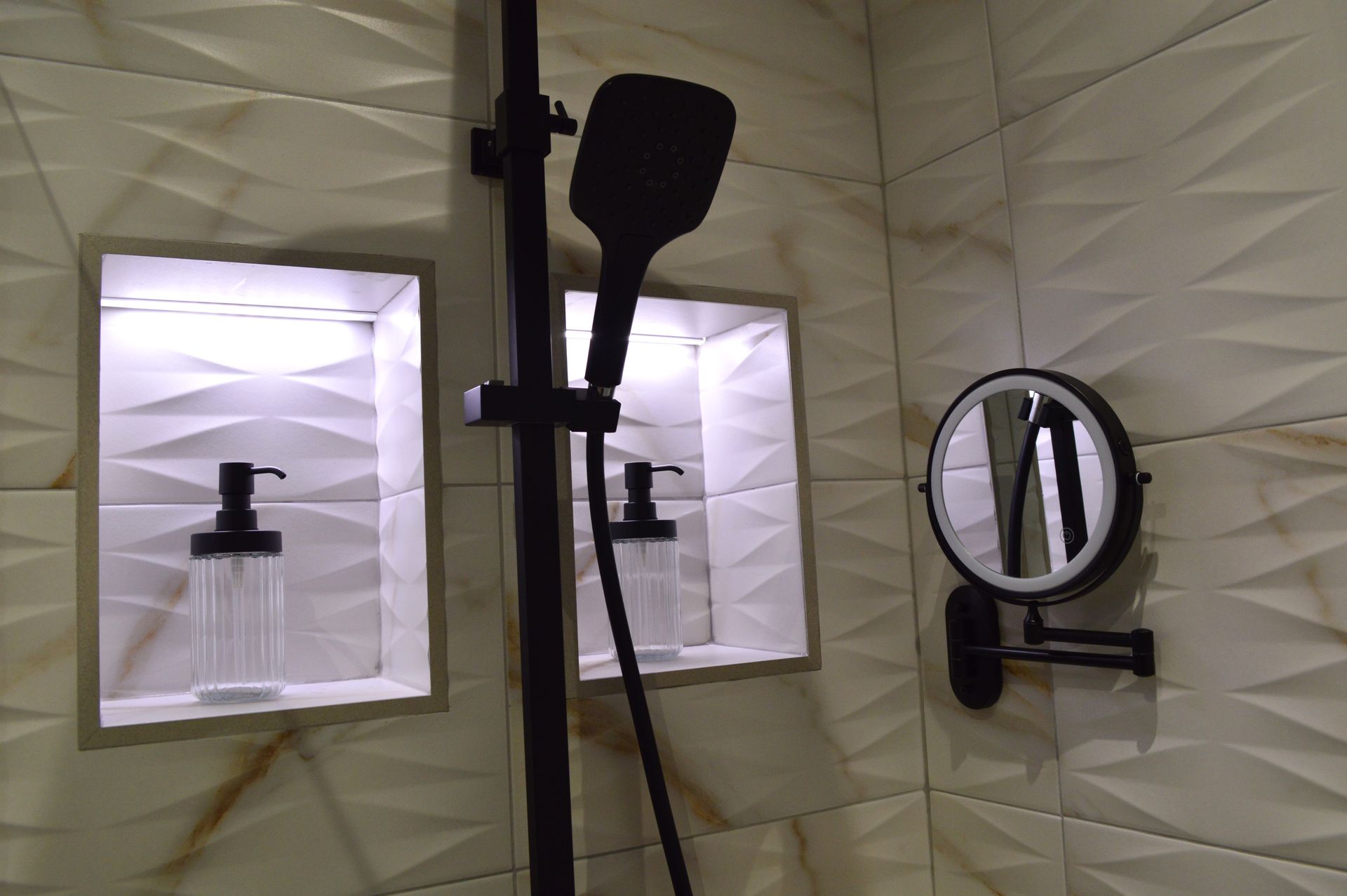 A bathroom with a shower head and a mirror