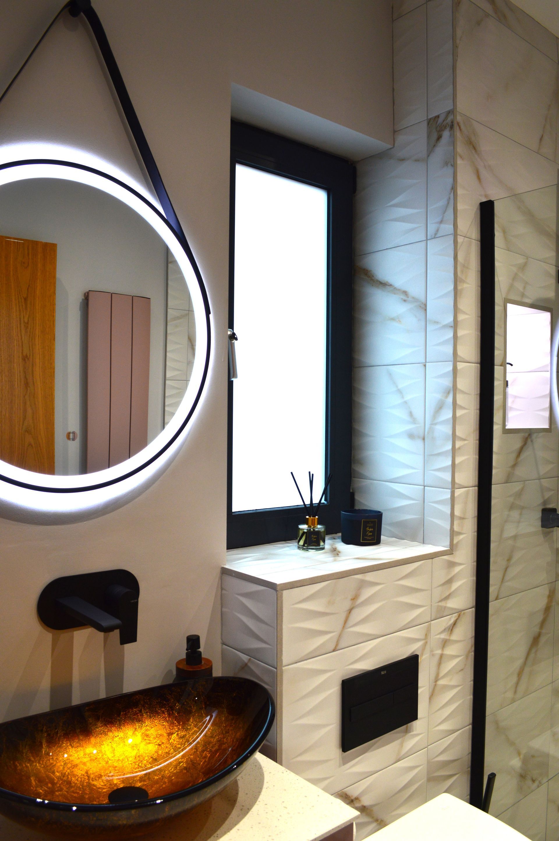 A bathroom with a sink , toilet , mirror and window.