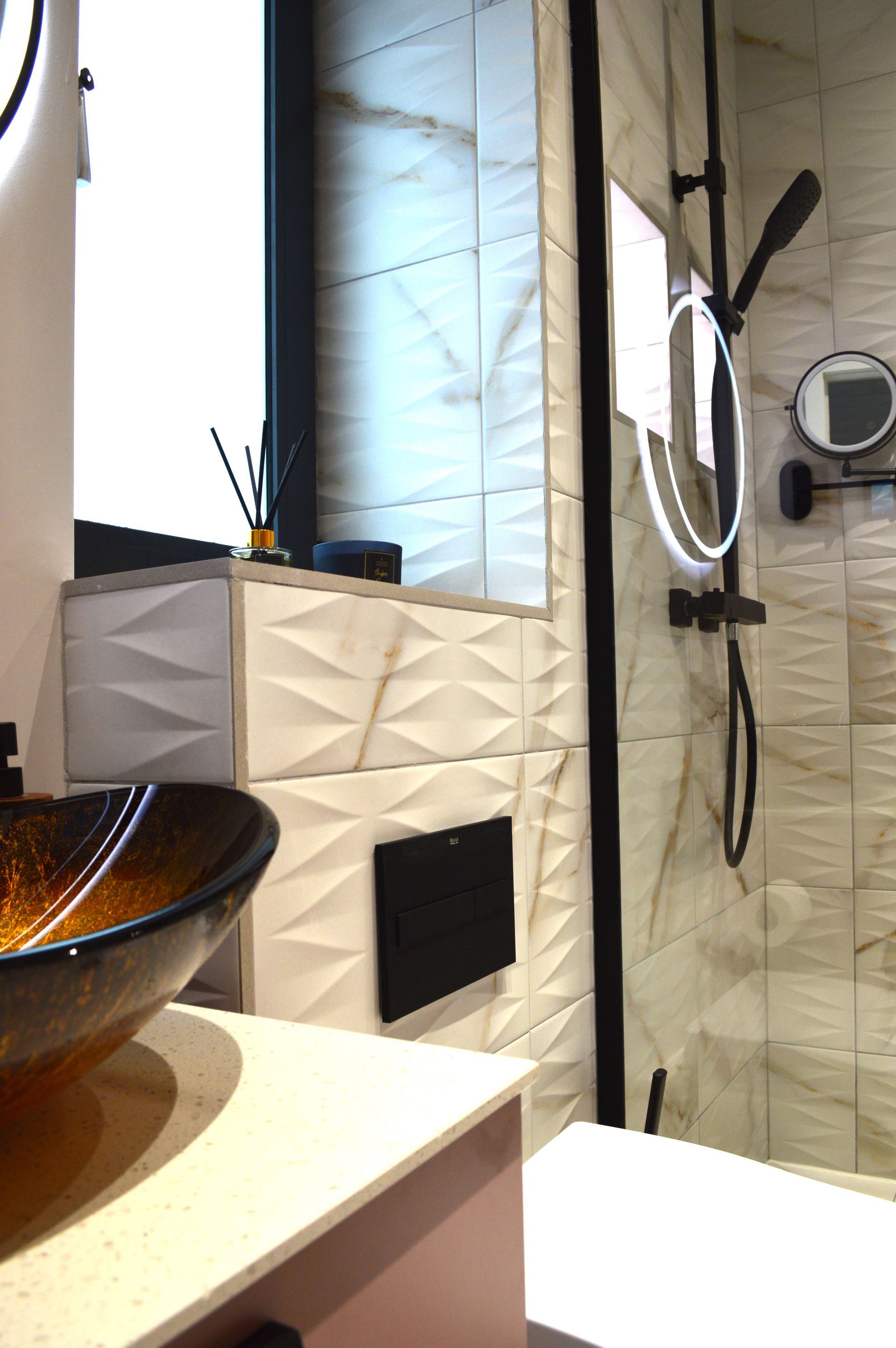 A bathroom with a sink , toilet , shower and mirror.