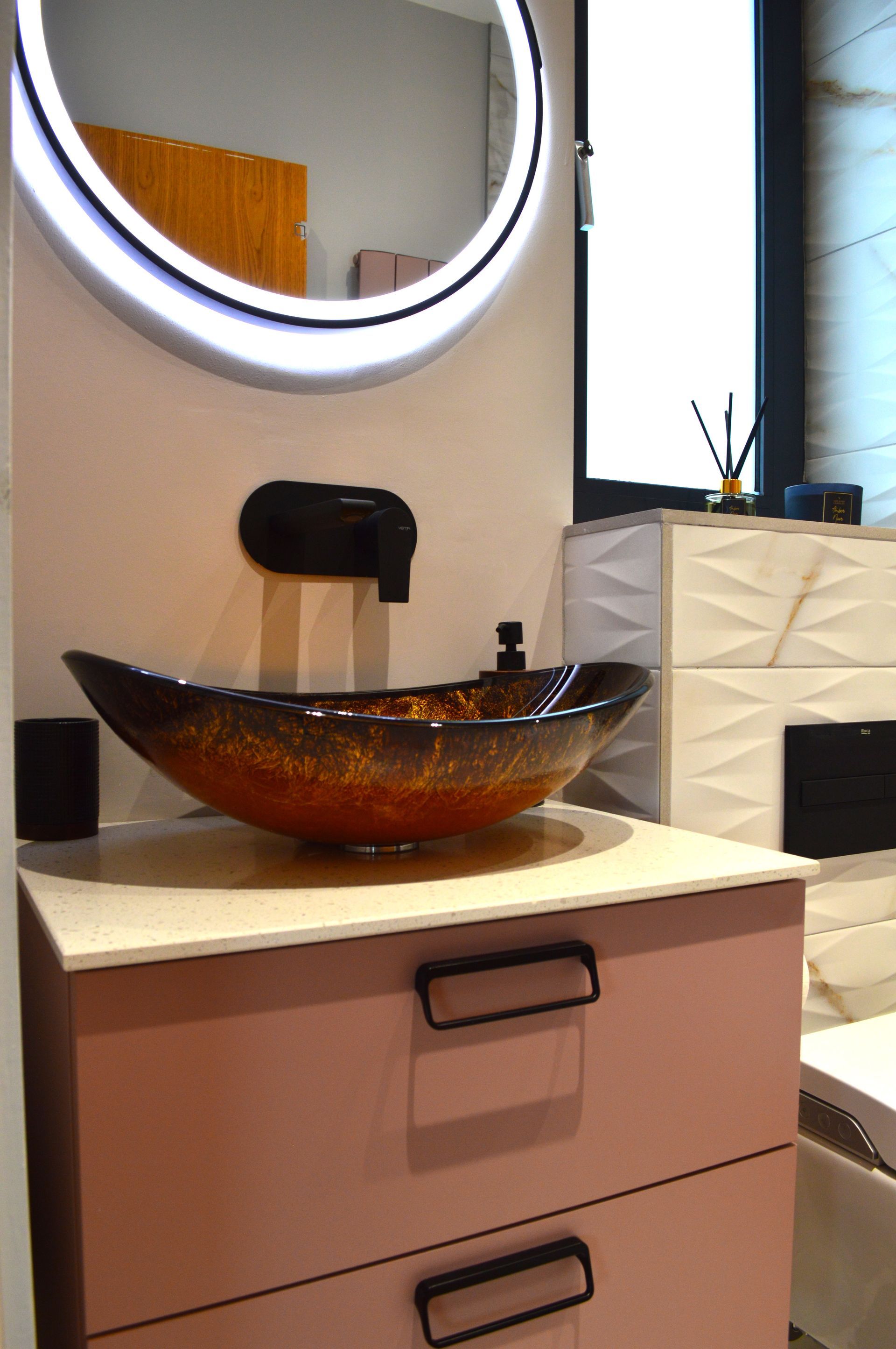 A bathroom with a sink , mirror and drawers.