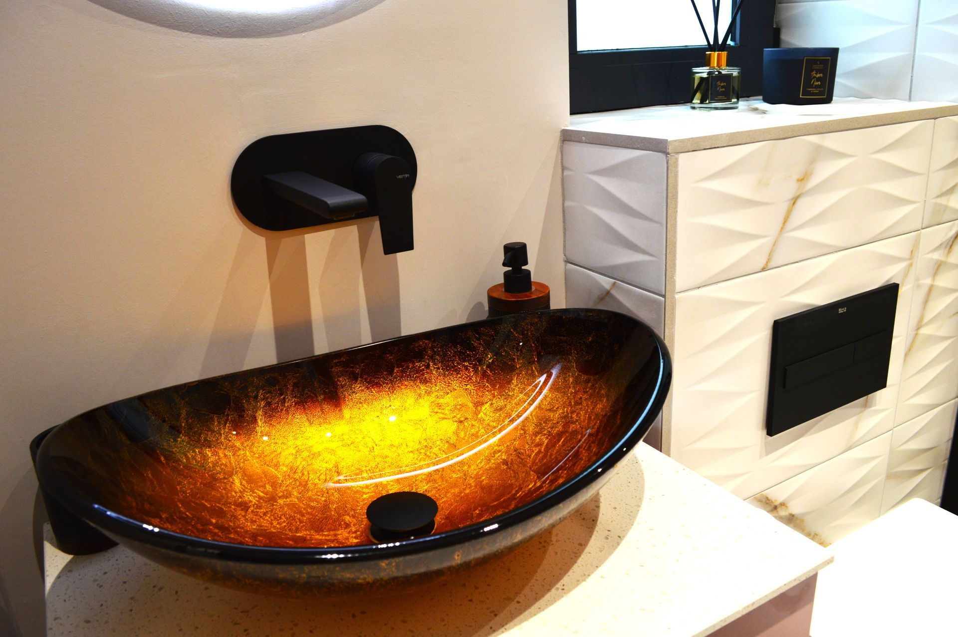 A bathroom with a sink and a black faucet