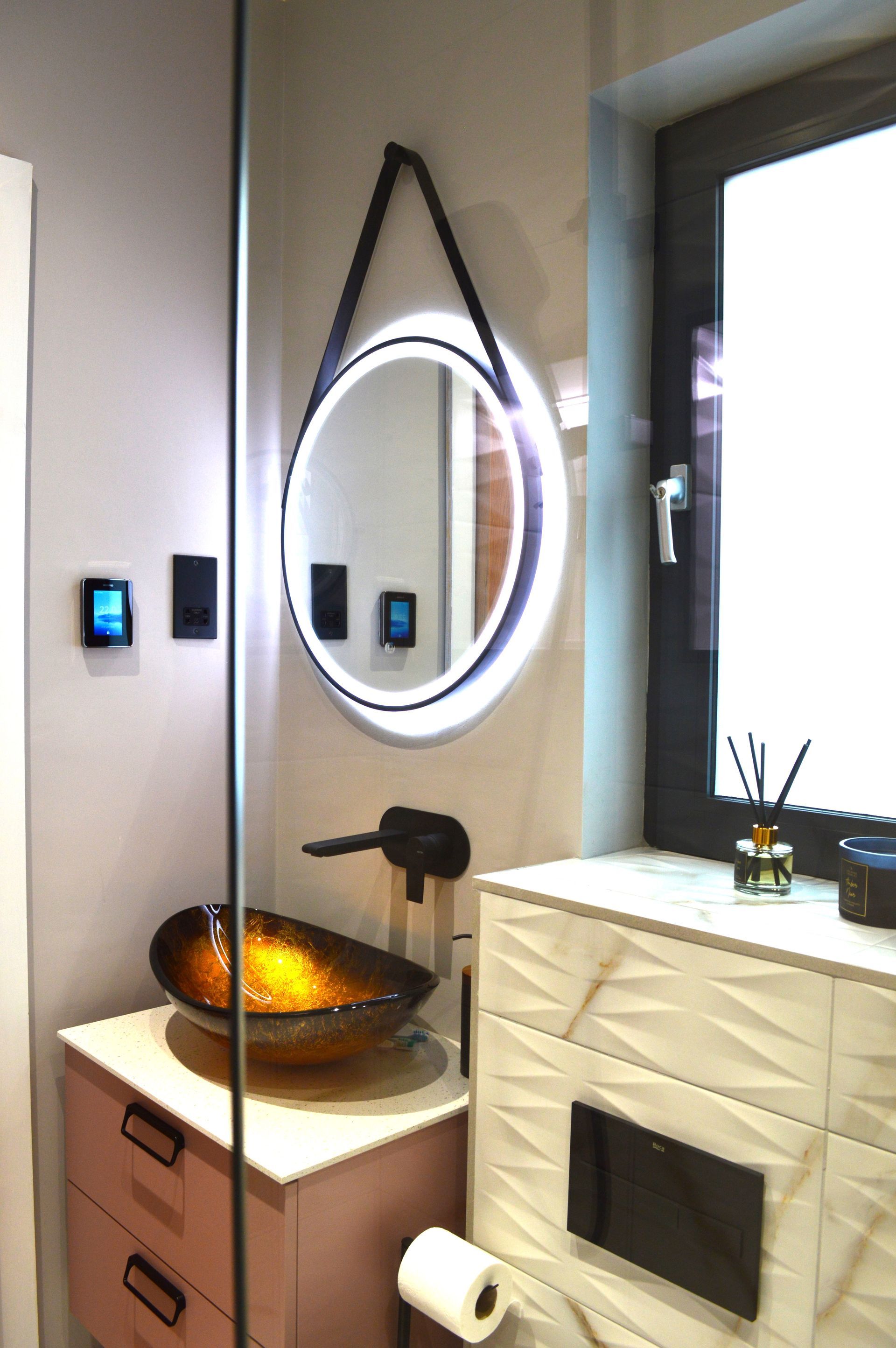 A bathroom with a sink a mirror and a window