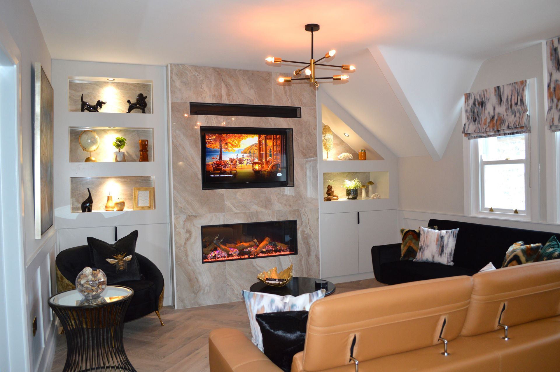 A living room with a fireplace and a flat screen tv on the wall.