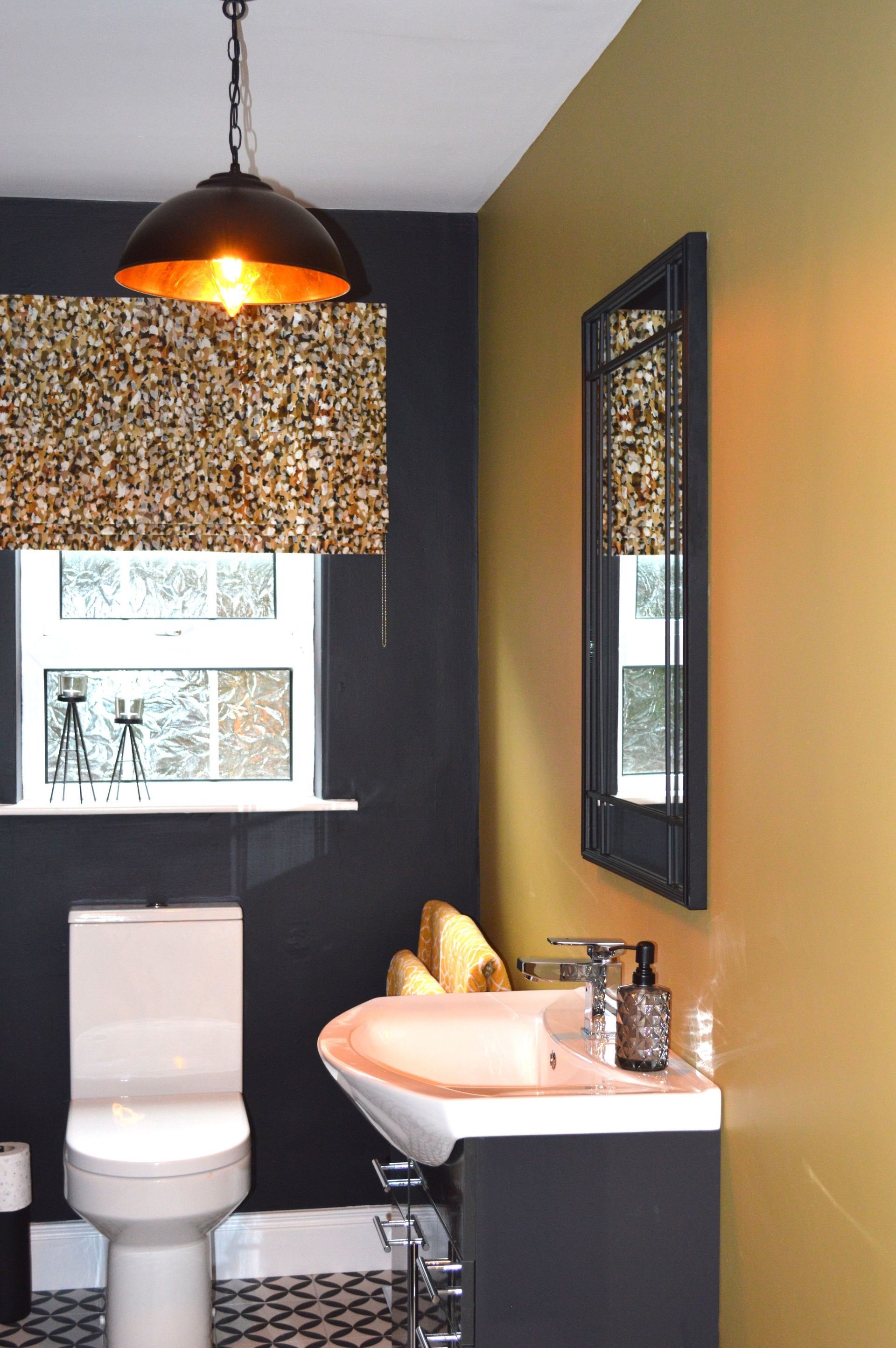 A bathroom with a toilet , sink and mirror