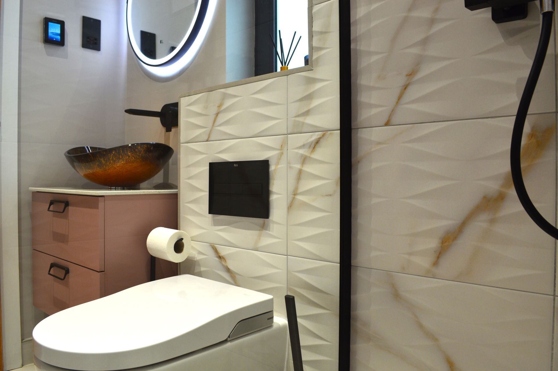 A bathroom with a toilet , sink , mirror and shower.