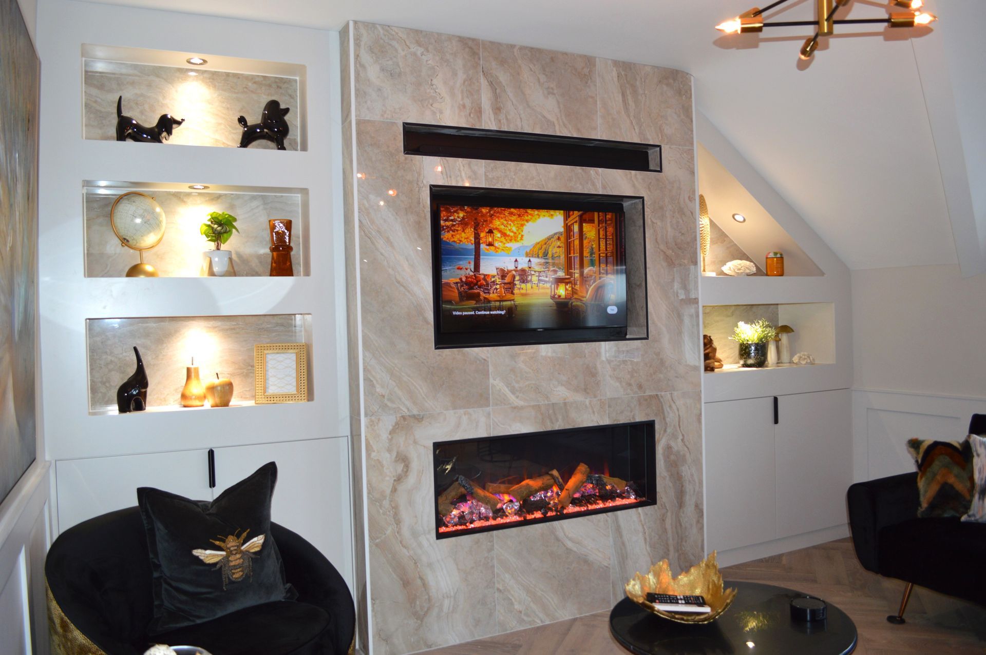 A living room with a fireplace and a flat screen tv