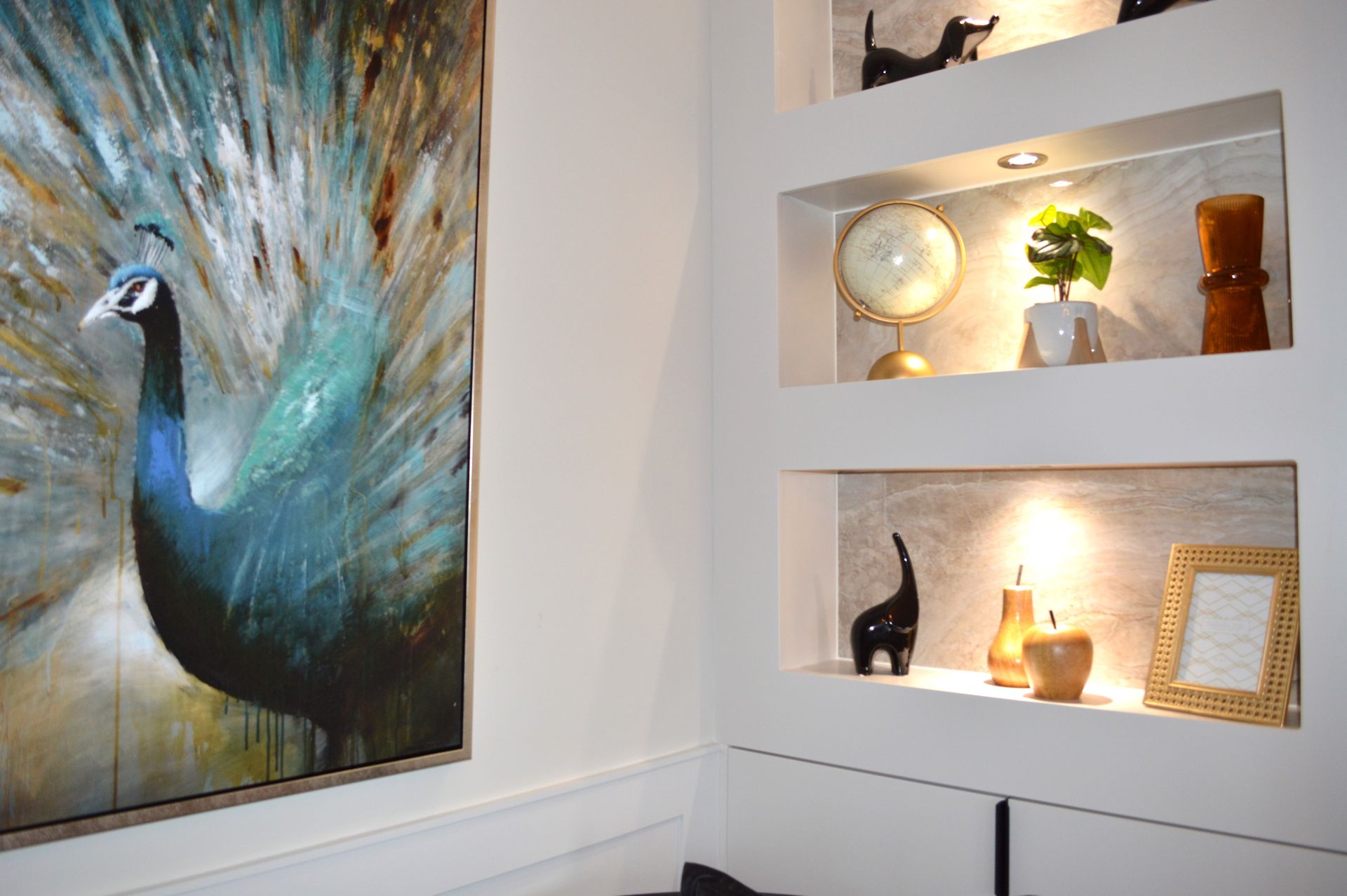 There is a painting of a peacock on the wall.