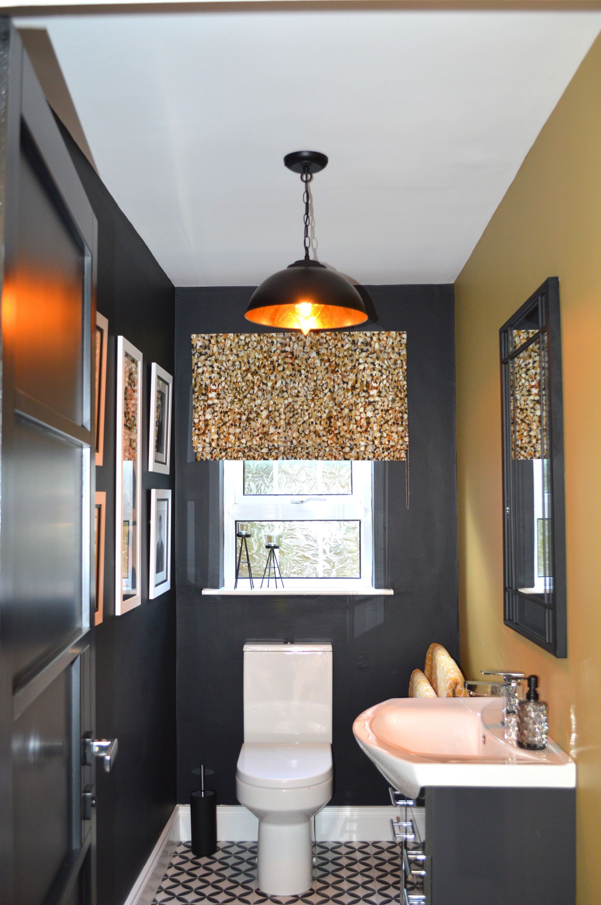 A bathroom with a toilet a sink and a mirror