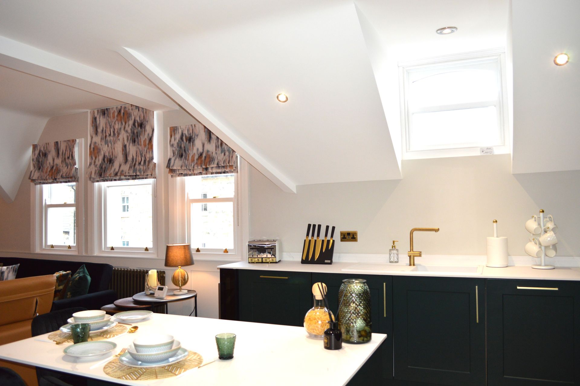A kitchen with black cabinets and a white counter top