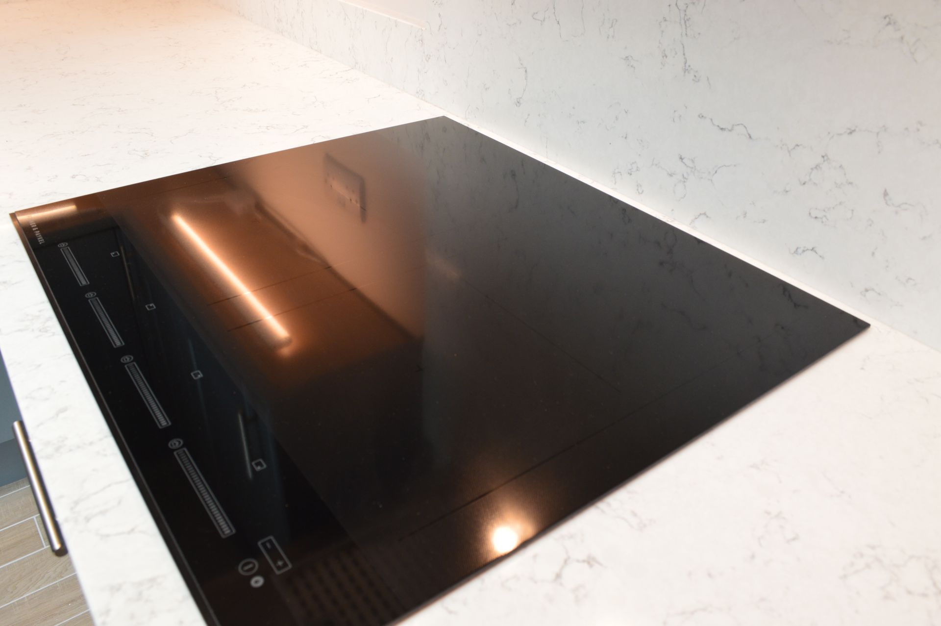 A black stove top oven is sitting on top of a white counter.