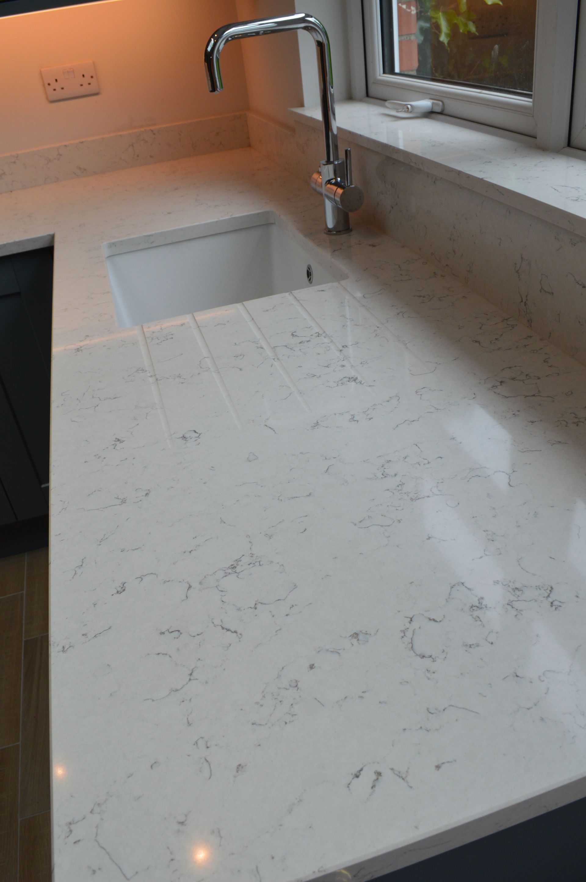 A kitchen counter with a sink and a faucet on it.