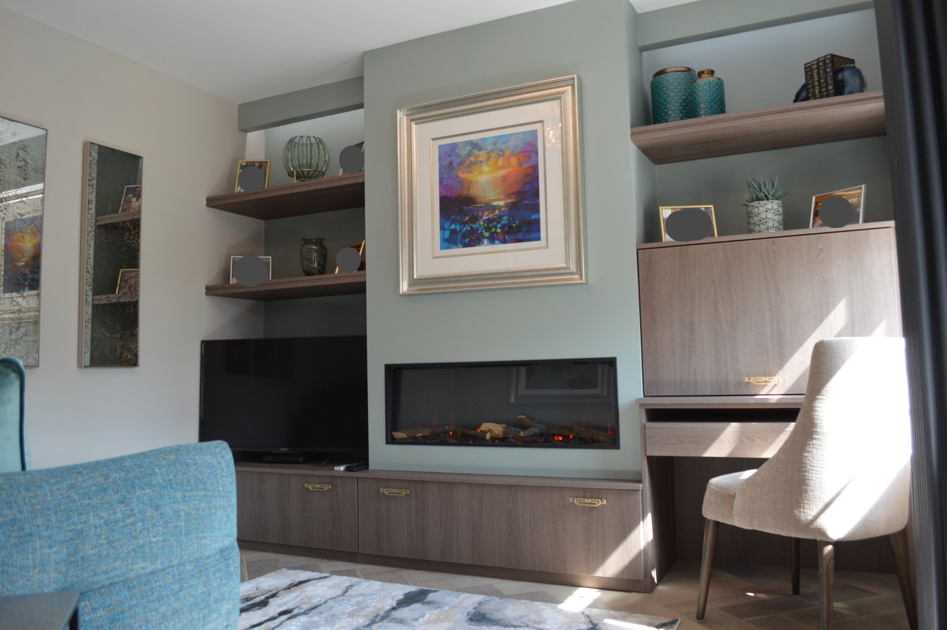 A living room with a fireplace , desk , chair and television.