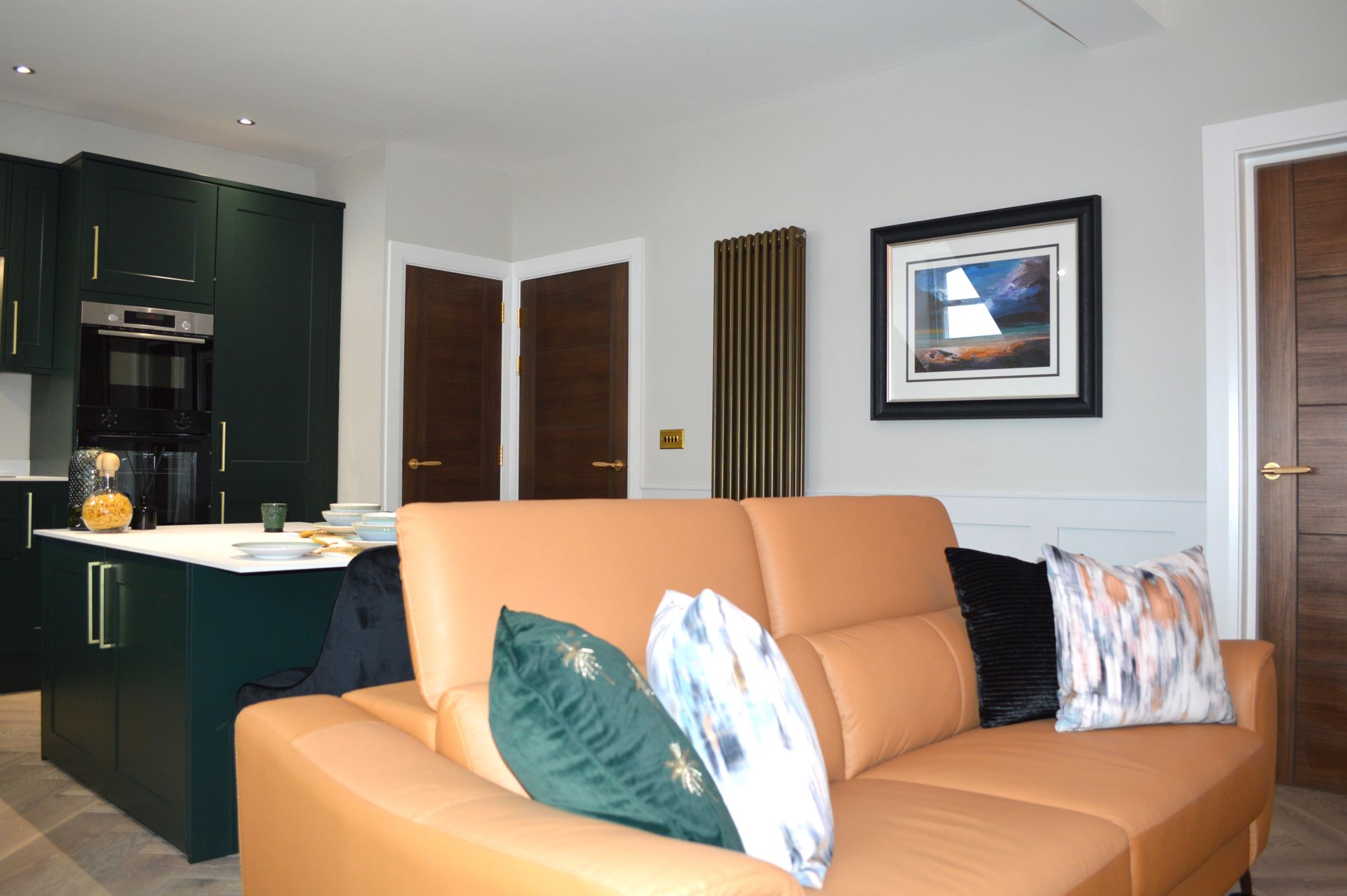 A living room with a couch and a picture on the wall.