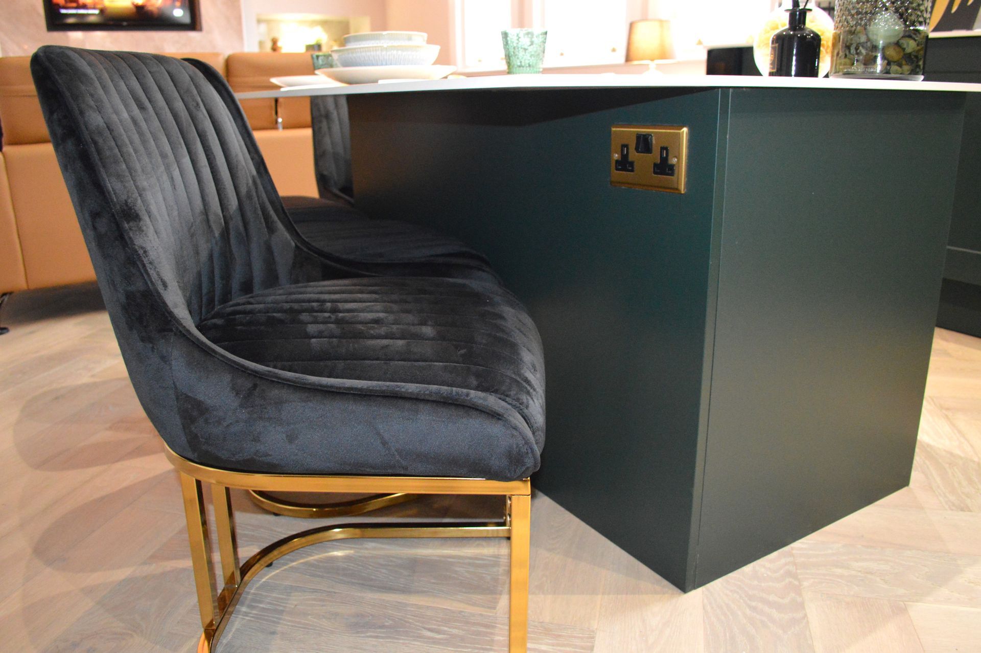 A black chair is sitting next to a green table.