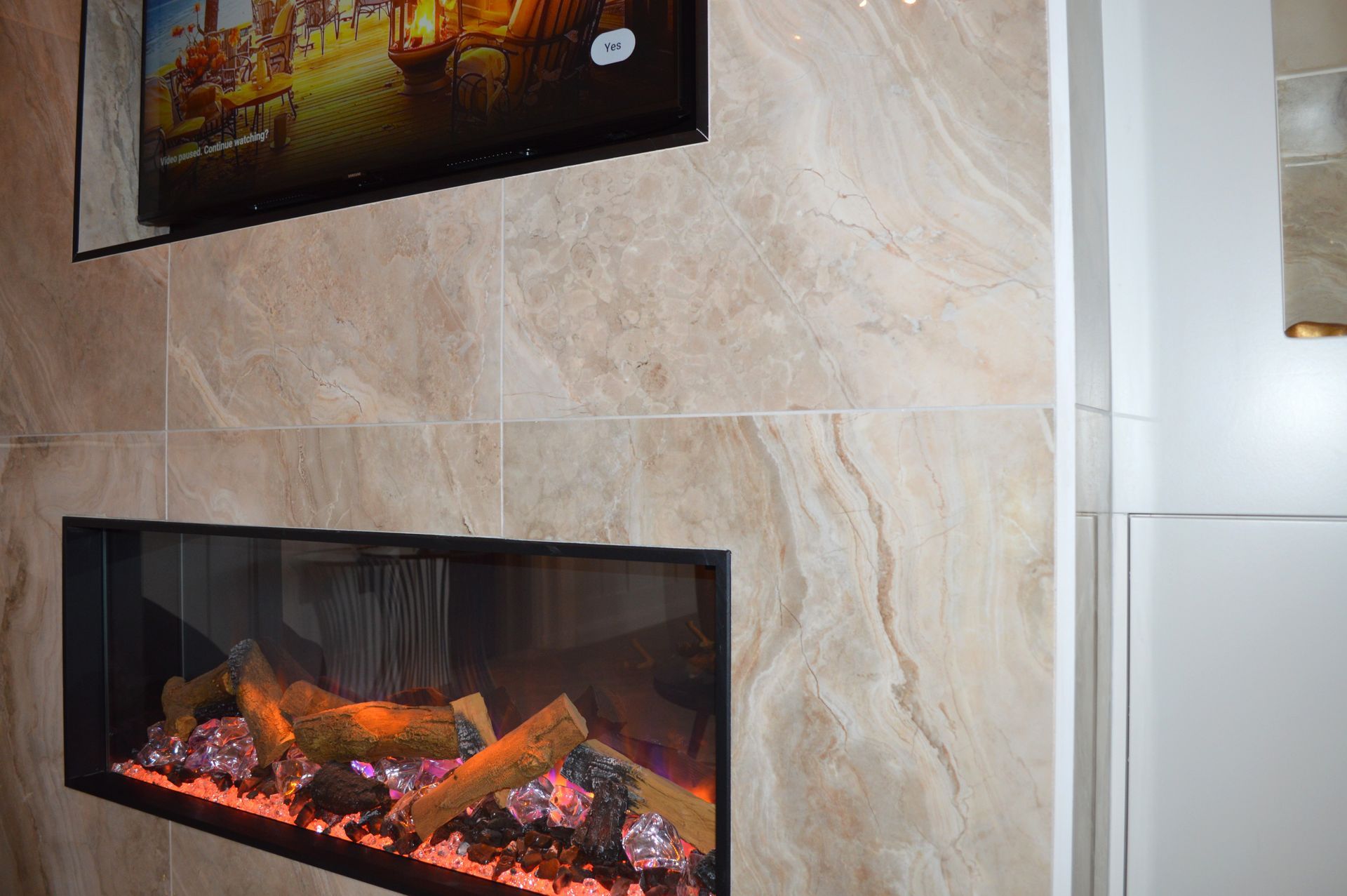 A fireplace with a television above it in a living room.