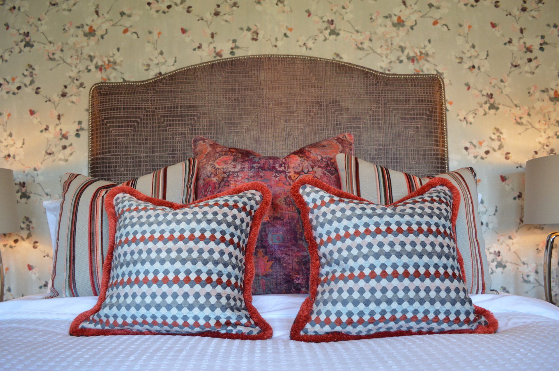 A bed with a headboard and two pillows on it.