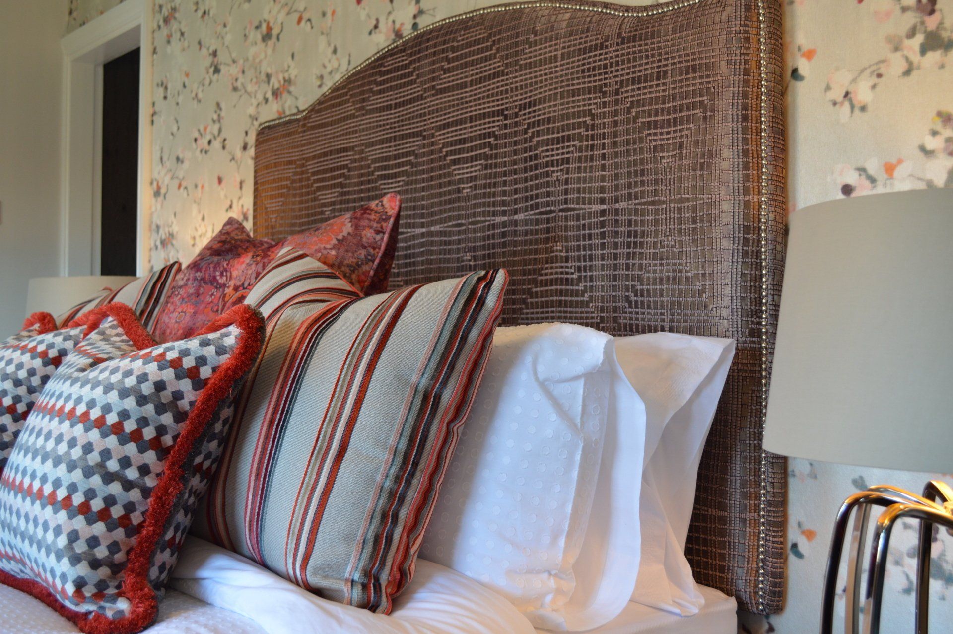 A bed with a headboard and pillows on it