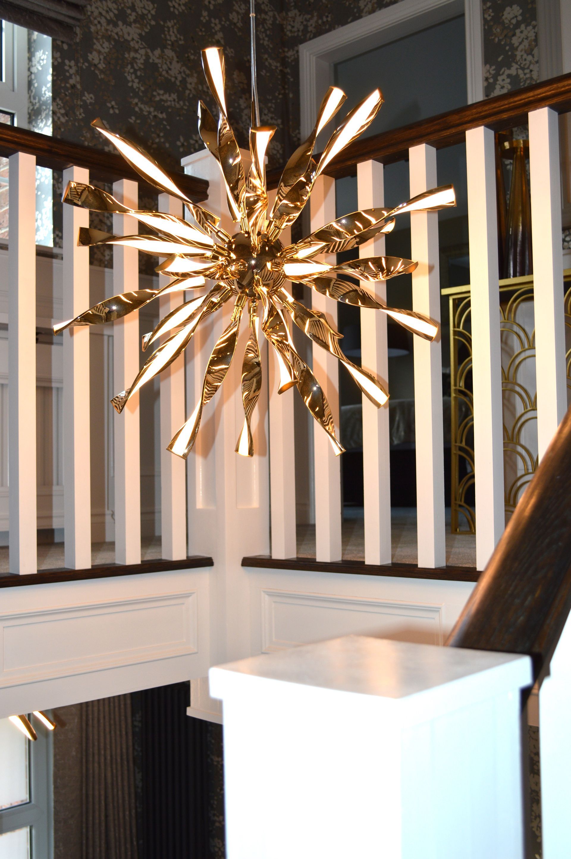 A staircase with a chandelier hanging from the ceiling