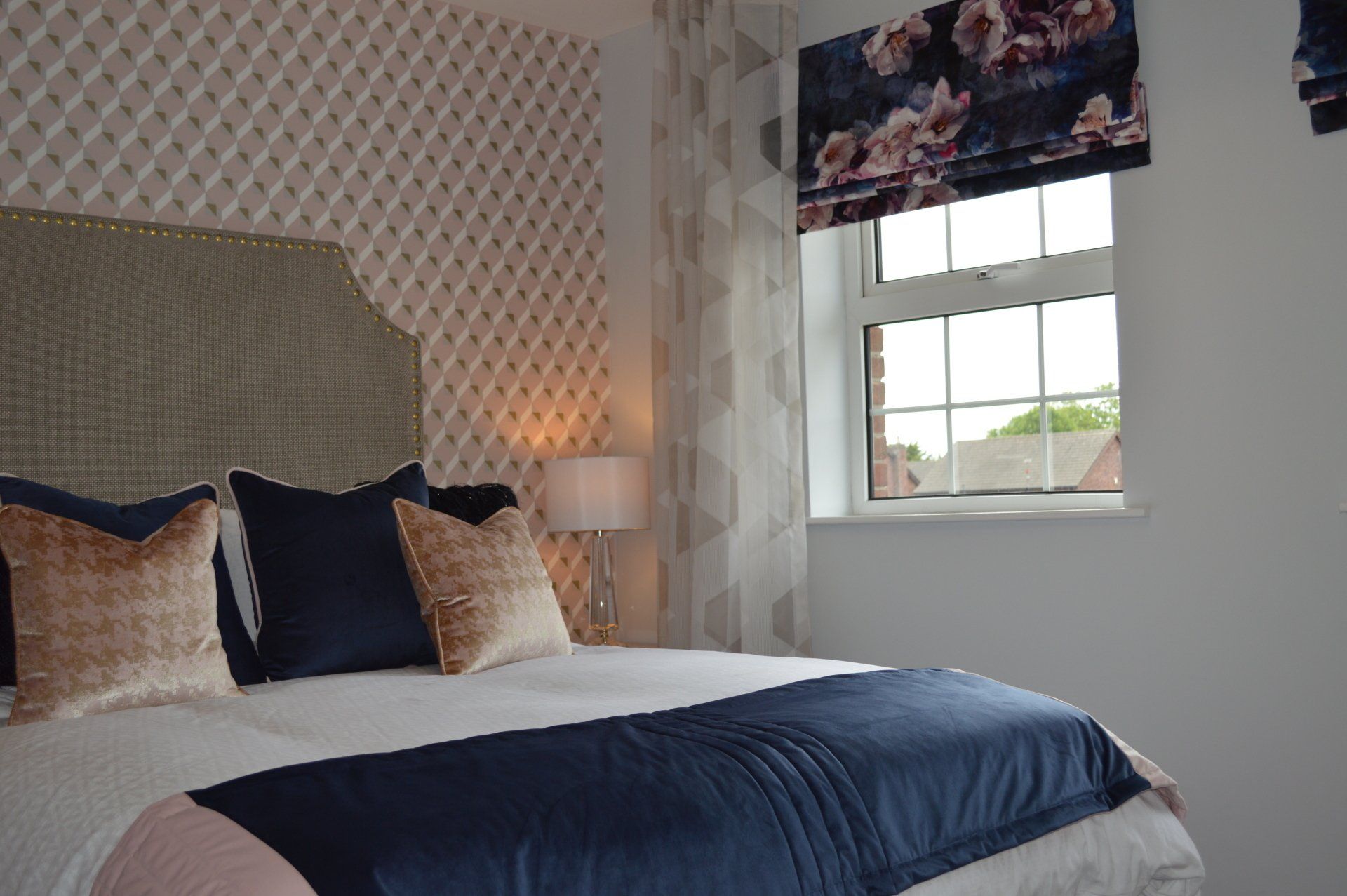 A bedroom with a large bed and a window.