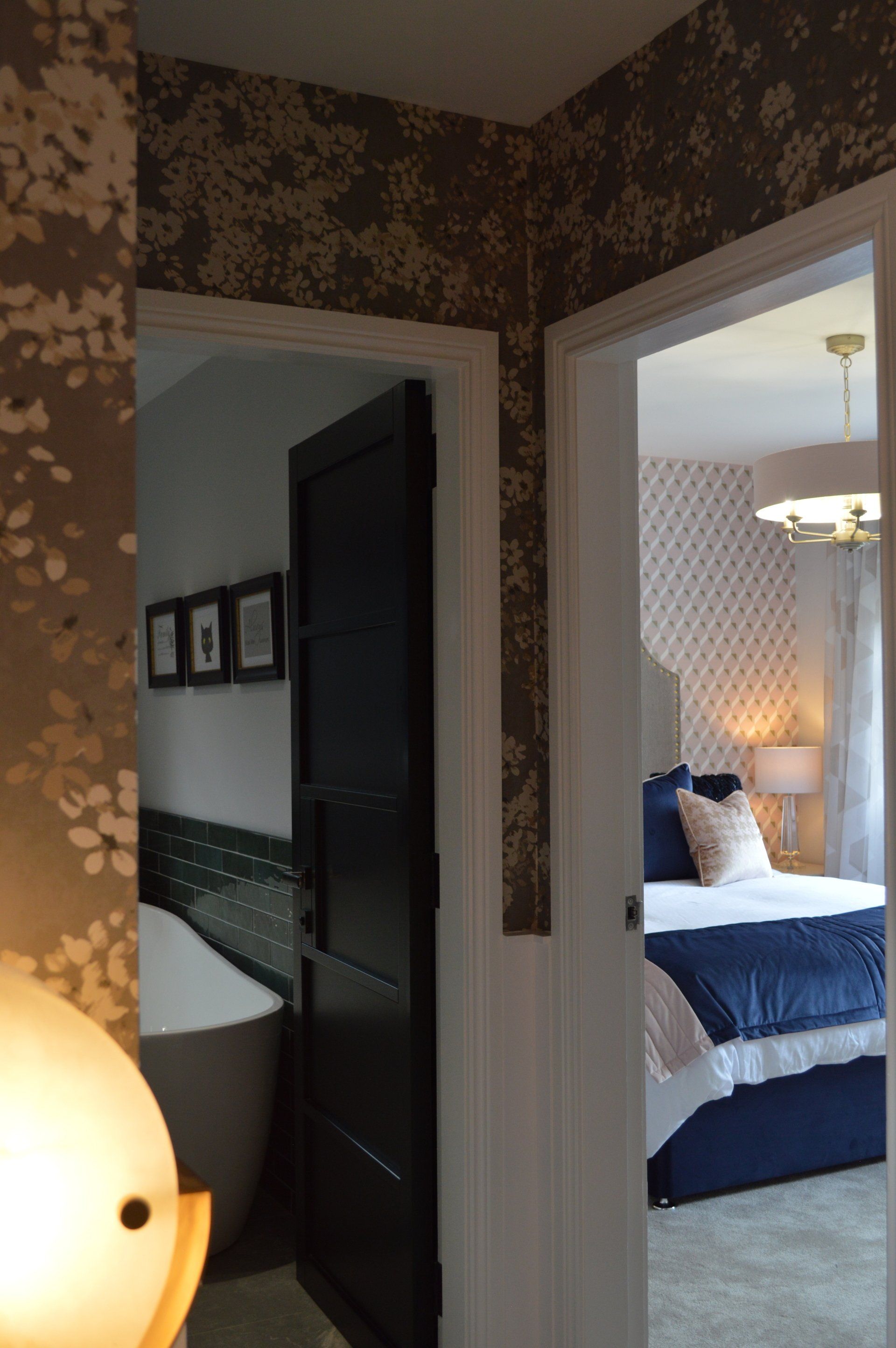 A bedroom with a bathtub and a bed