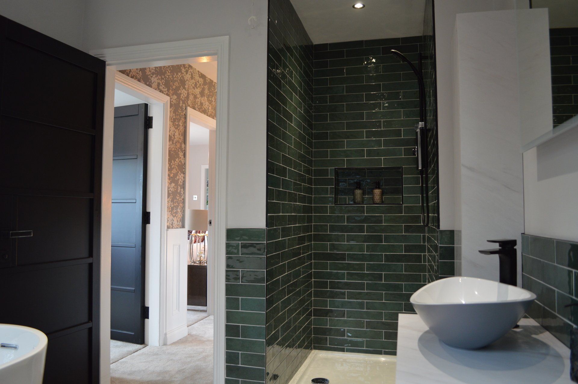 A bathroom with two sinks and a walk in shower