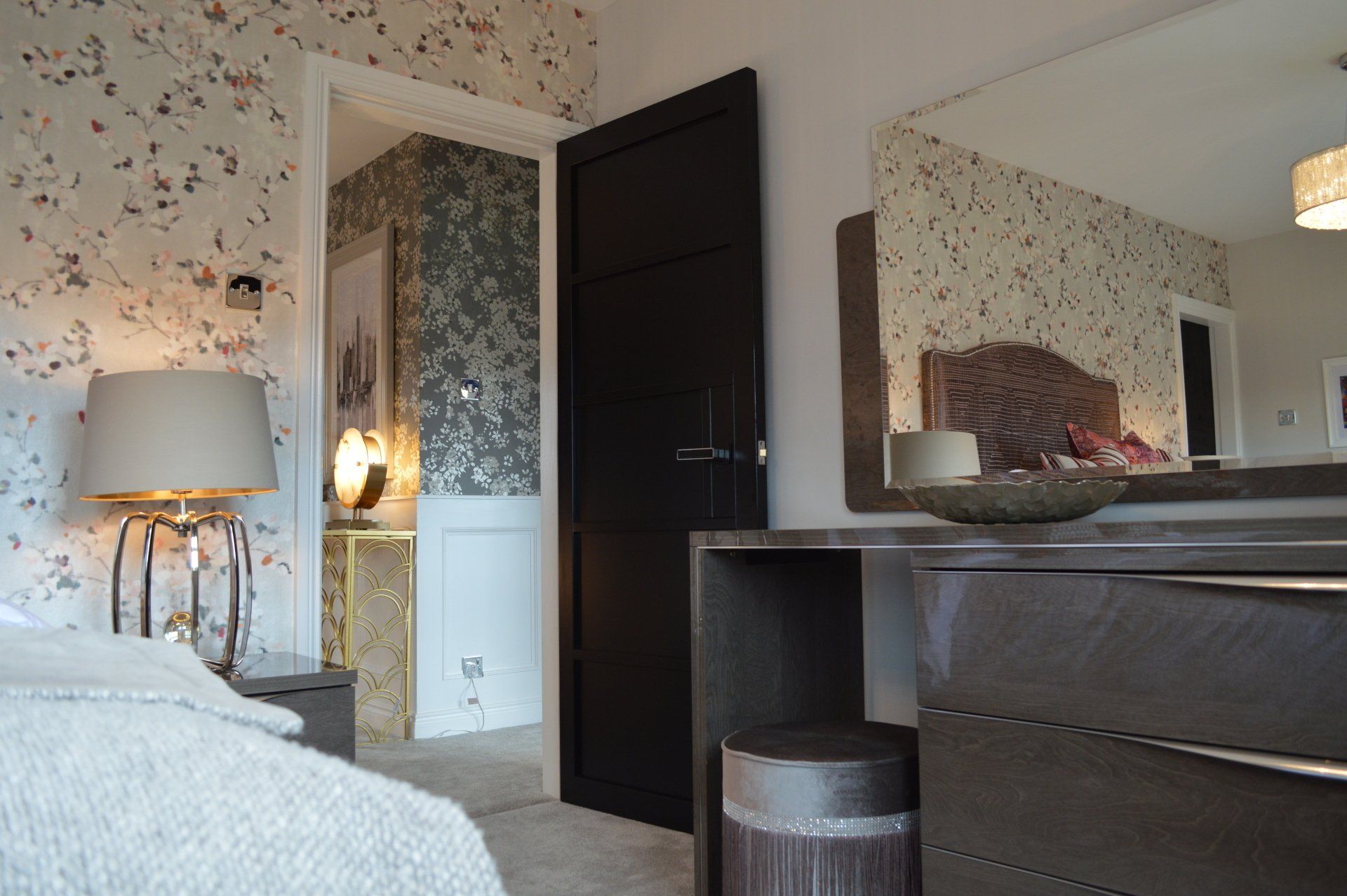 A bedroom with a bed dresser and mirror