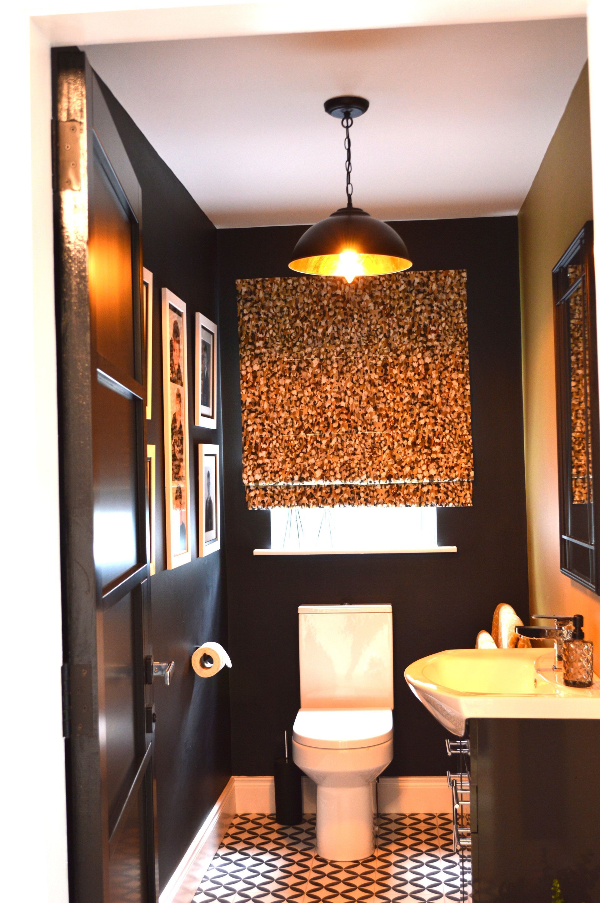 A bathroom with a toilet , sink and mirror