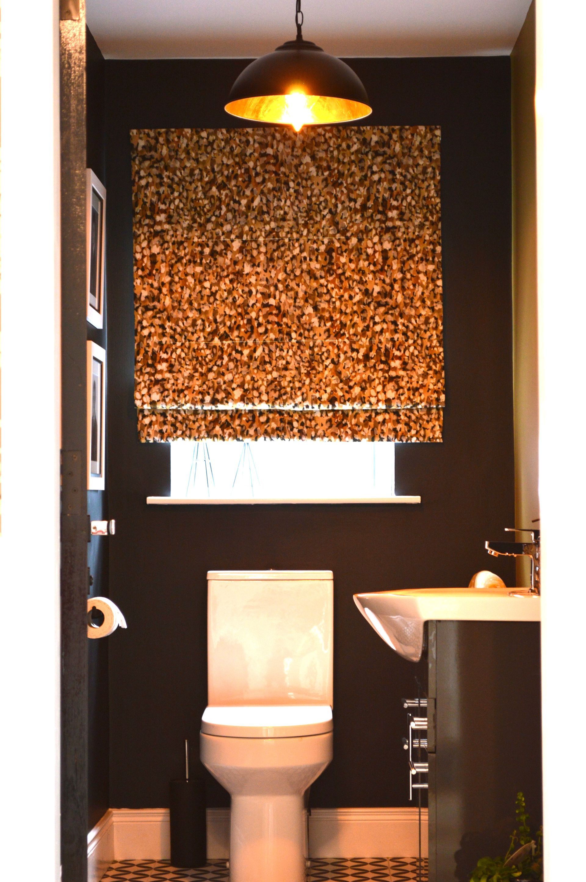 A bathroom with a toilet a sink and a window