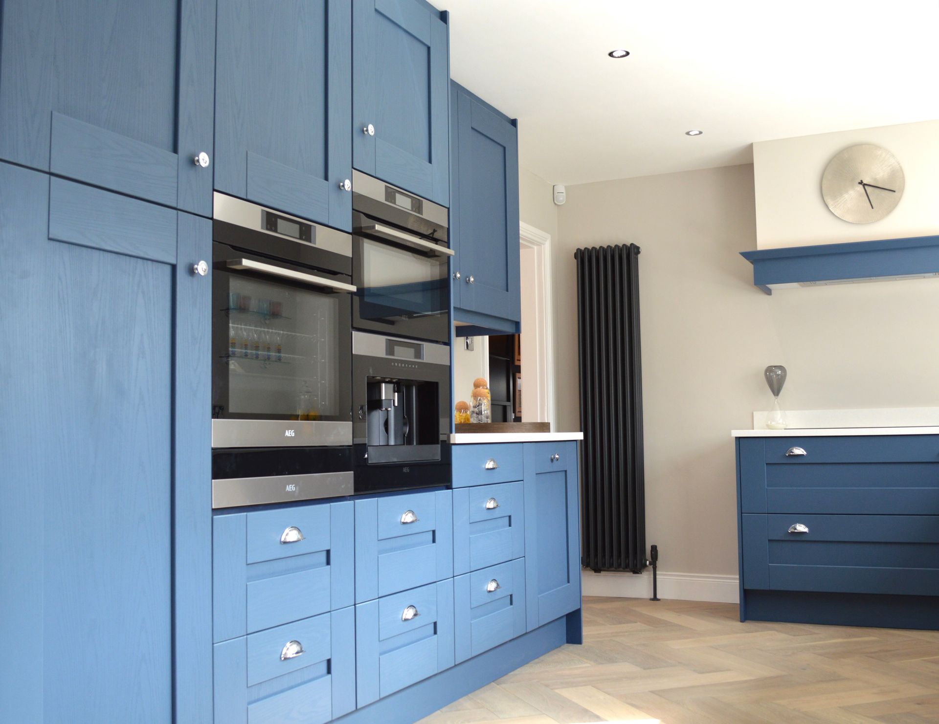 A kitchen with blue cabinets and stainless steel appliances