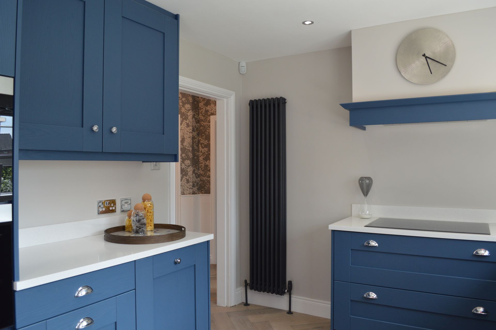 A kitchen with blue cabinets and stainless steel appliances