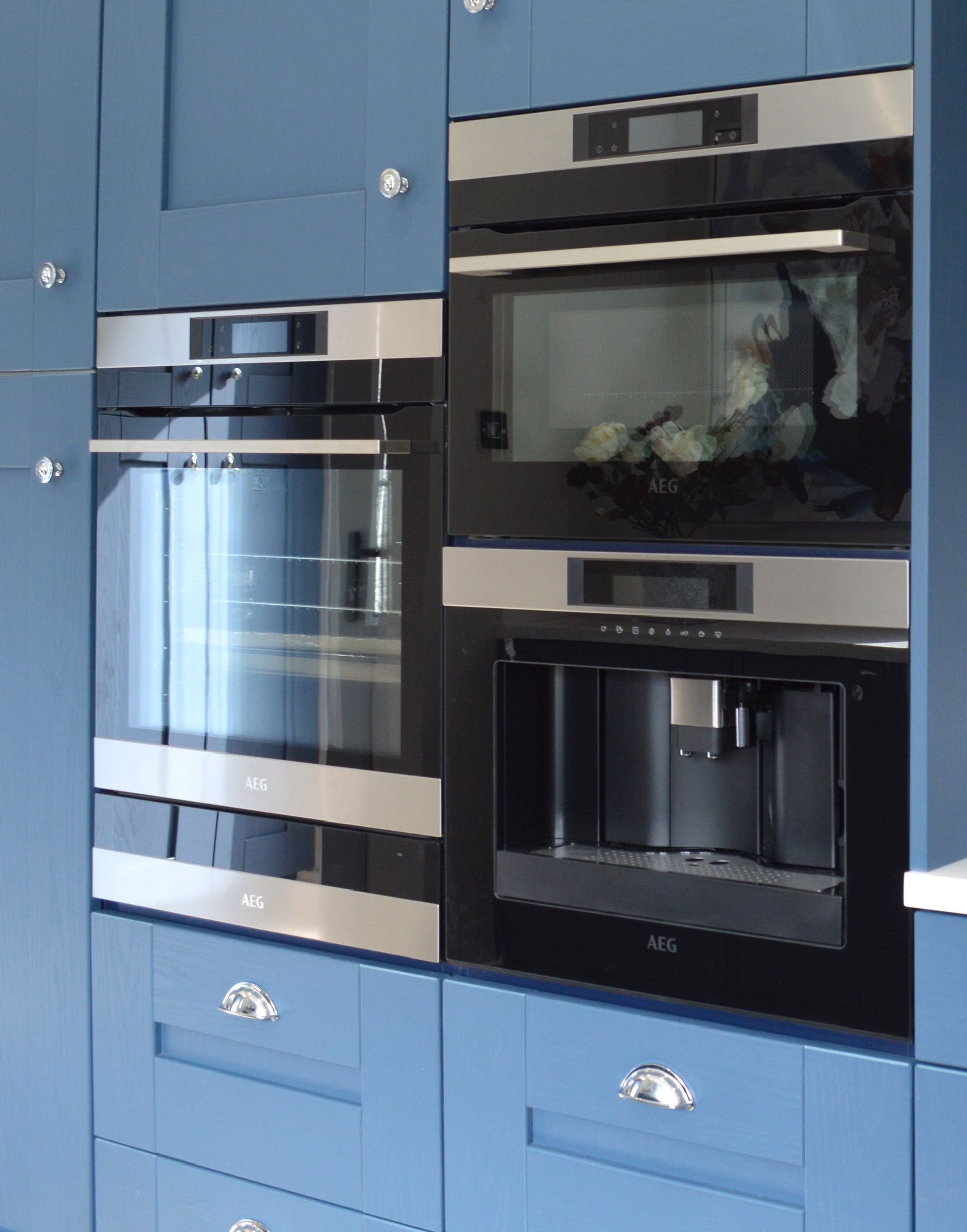 A kitchen with a sink and a clock on the wall.