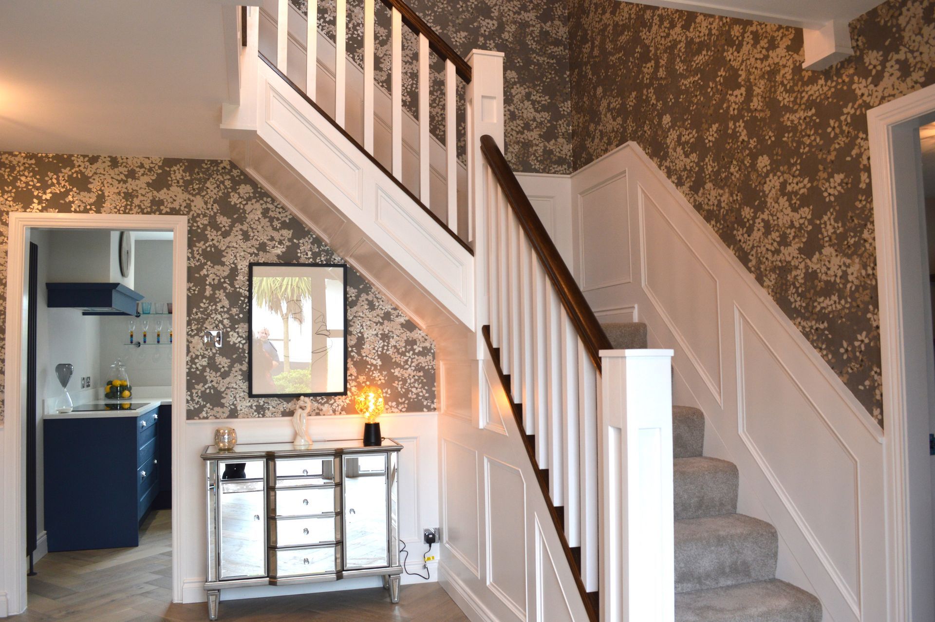 A staircase in a house with a picture on the wall