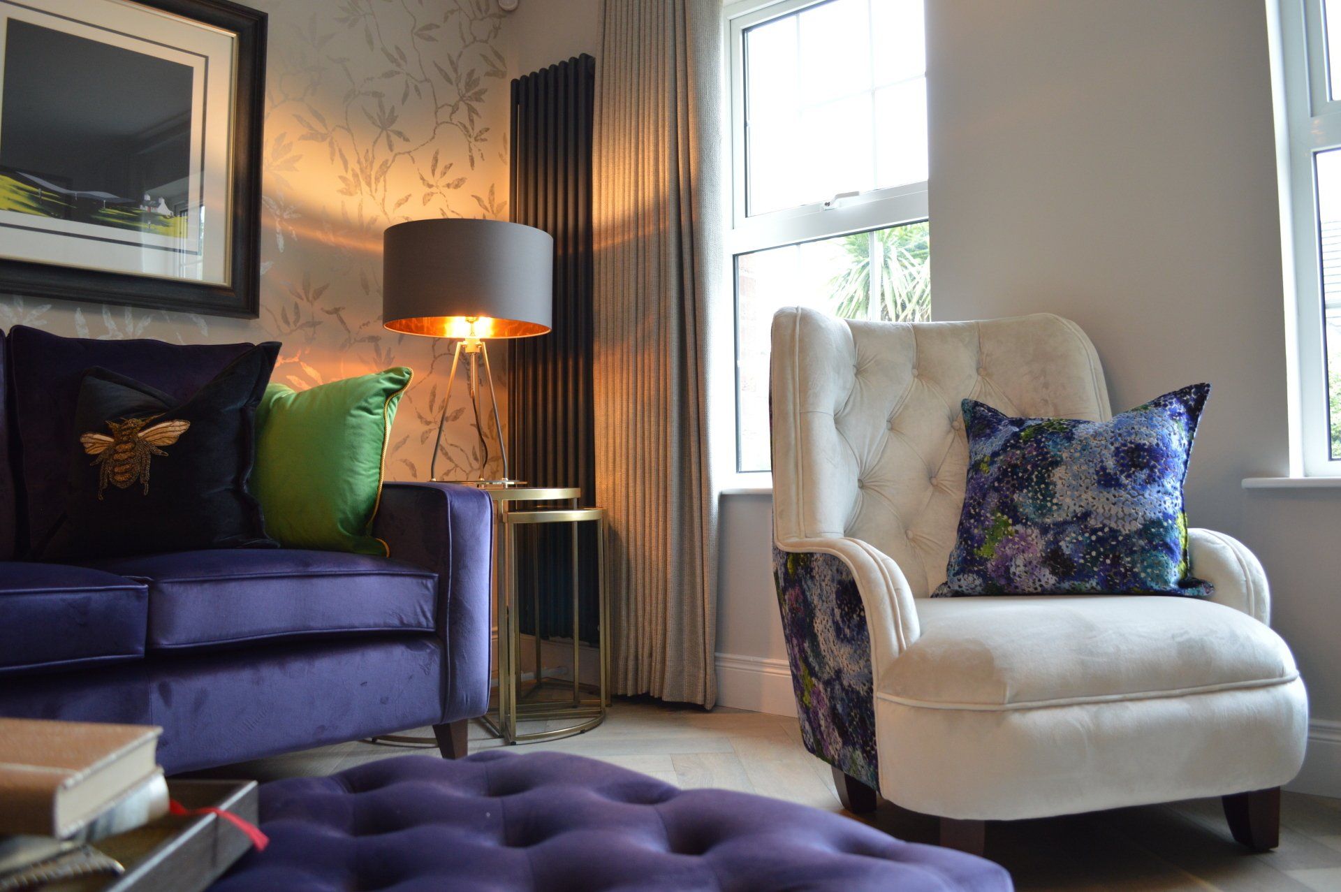 There is a purple couch and a white chair in the living room.