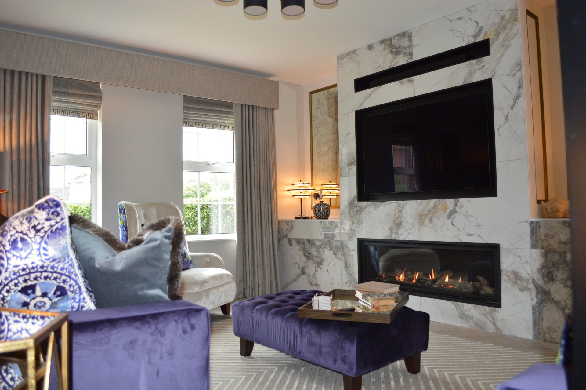A living room with a fireplace and a flat screen tv.