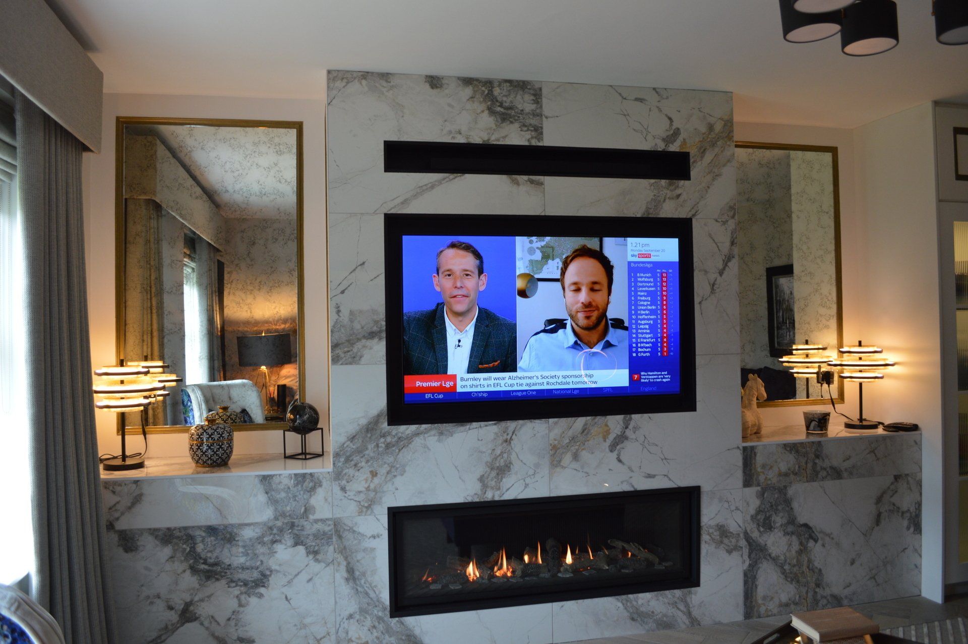 A living room with a fireplace and a flat screen tv
