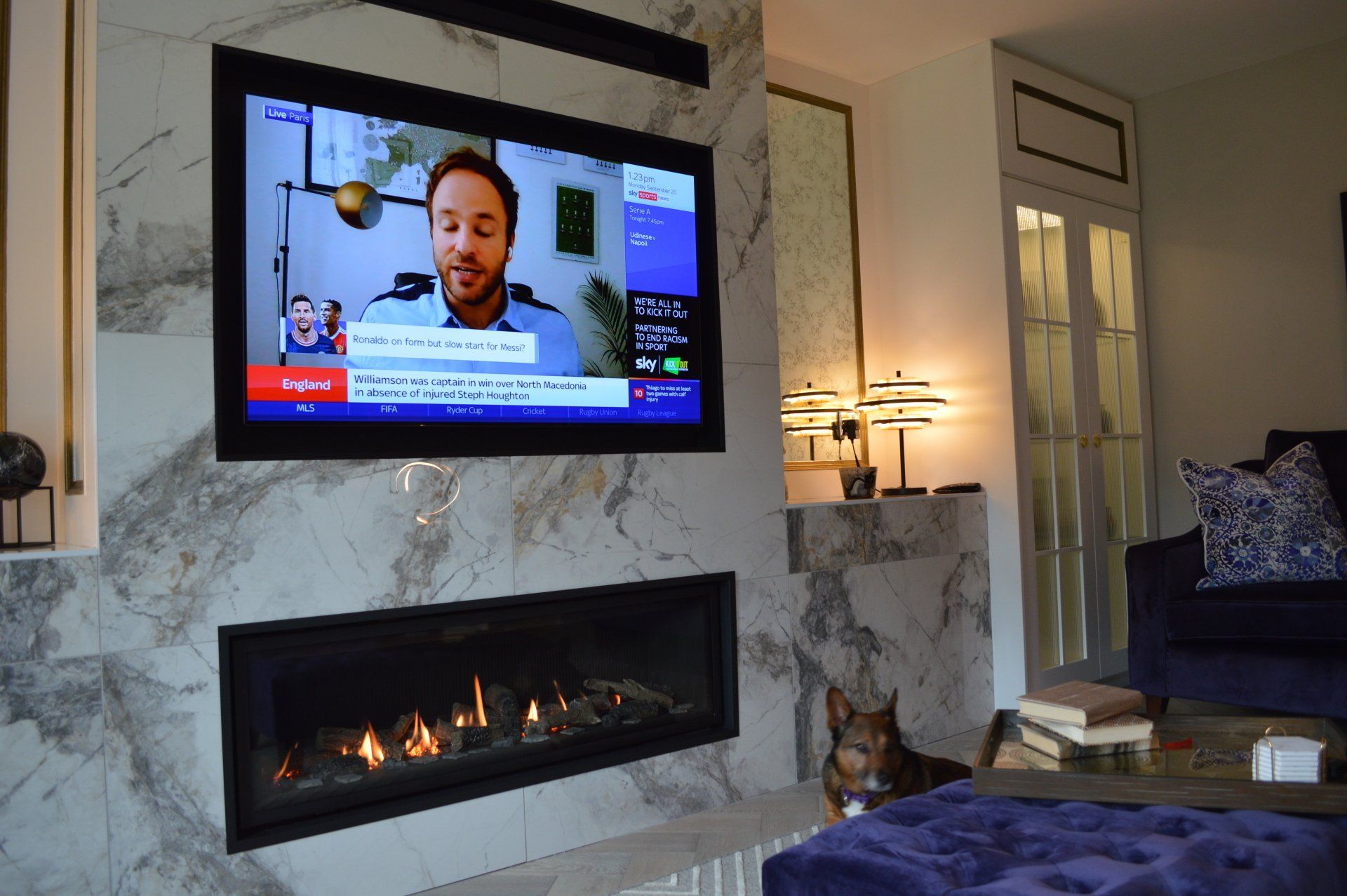 A living room with a fireplace and a flat screen tv