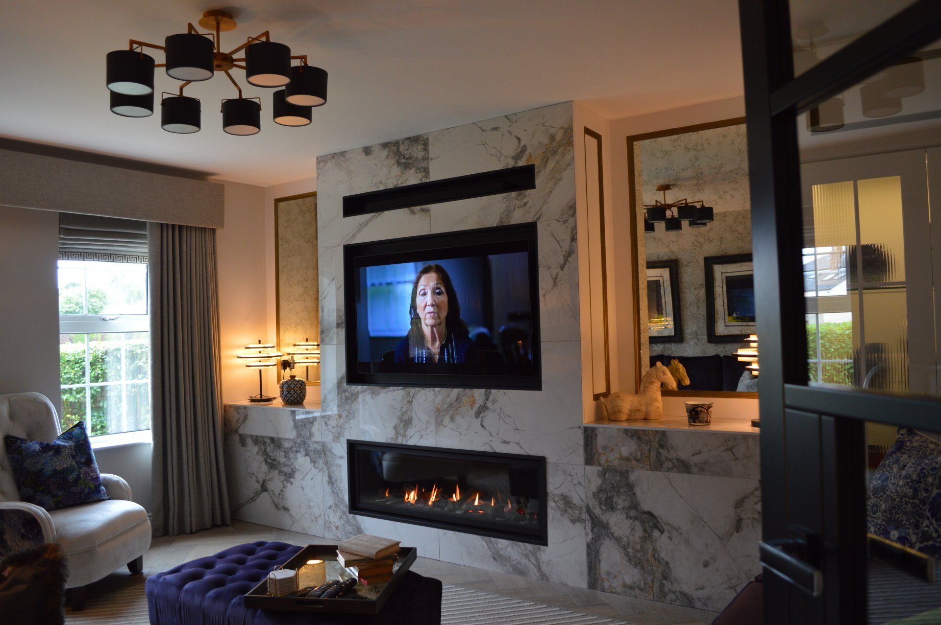 A living room with a fireplace and a flat screen tv