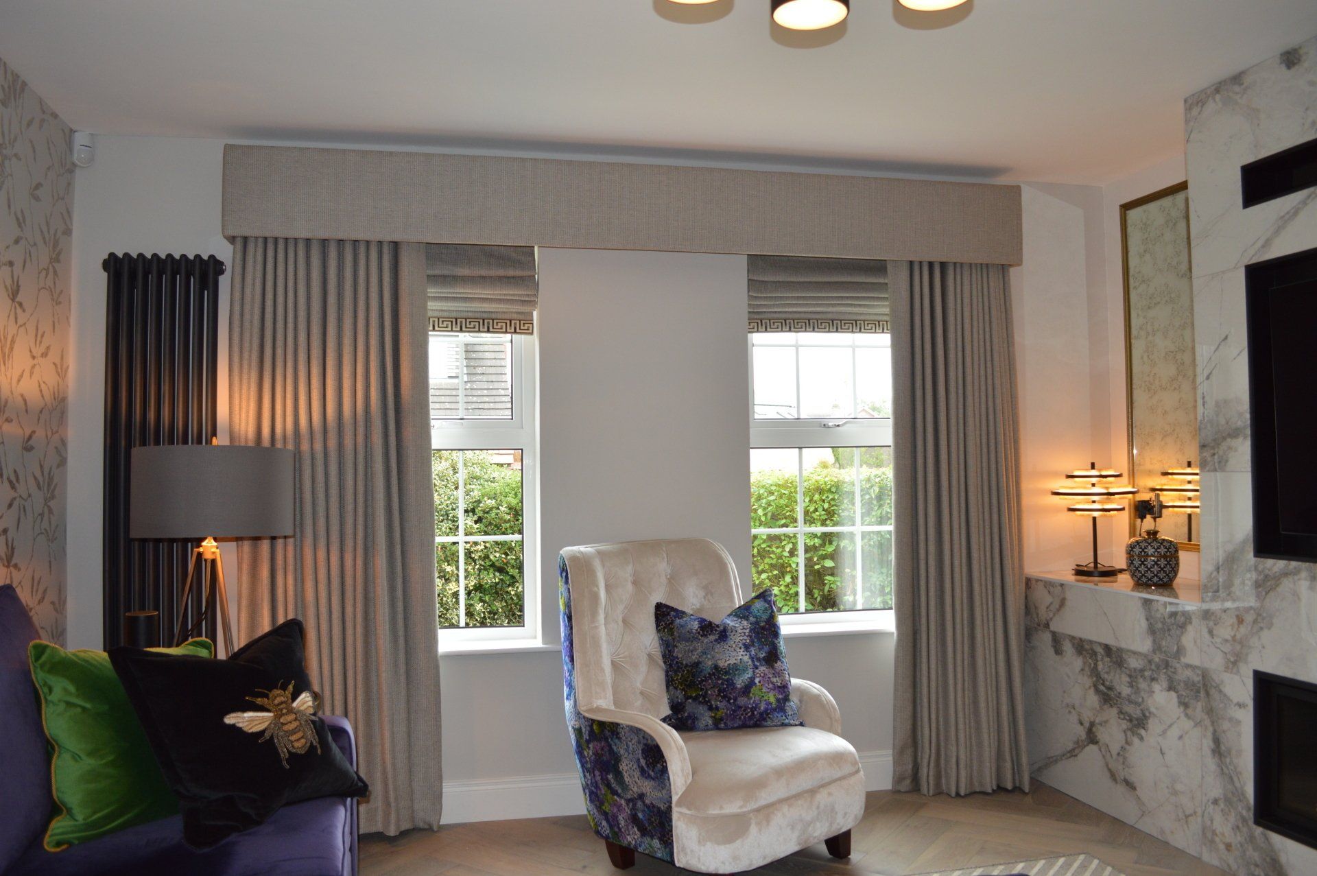 A living room with a couch , chair , and television.