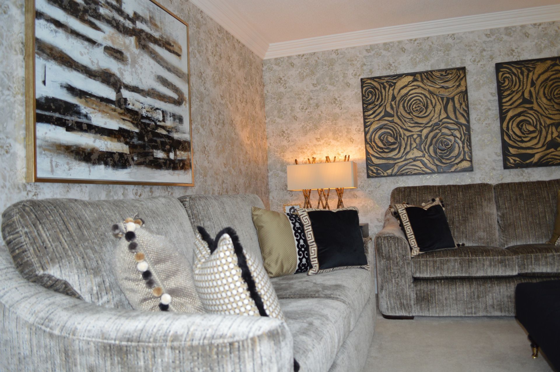 A living room with a couch a chair and a lamp