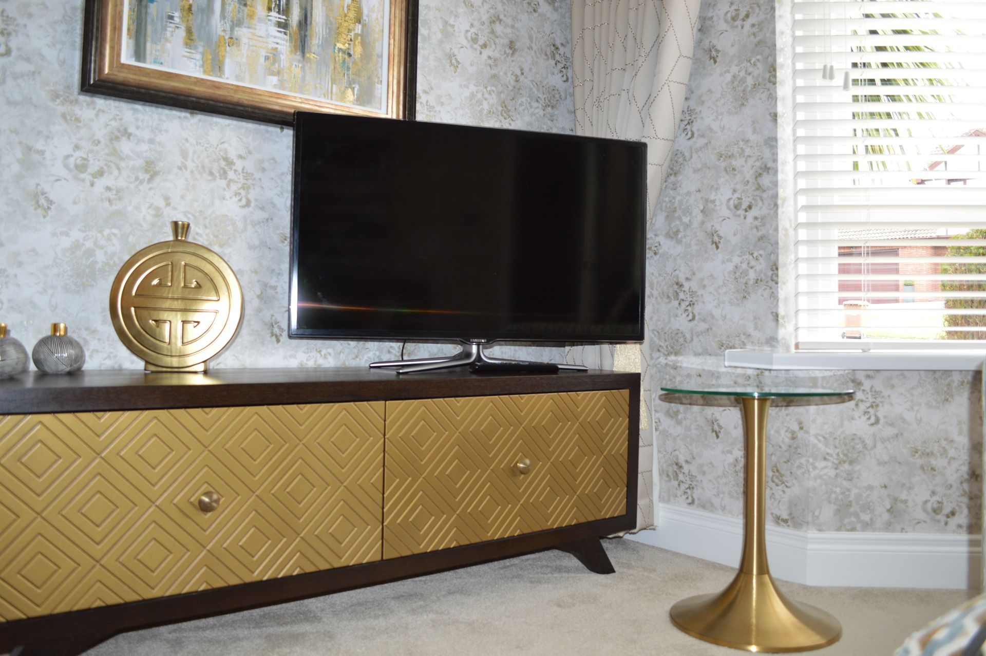 A living room with a television and a table