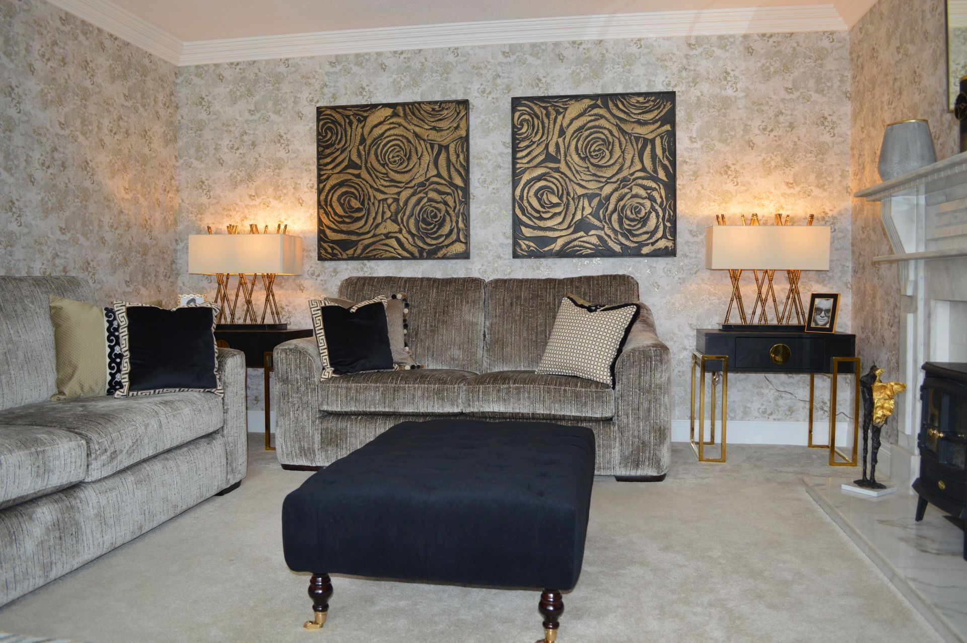 A living room with a couch ottoman and two lamps