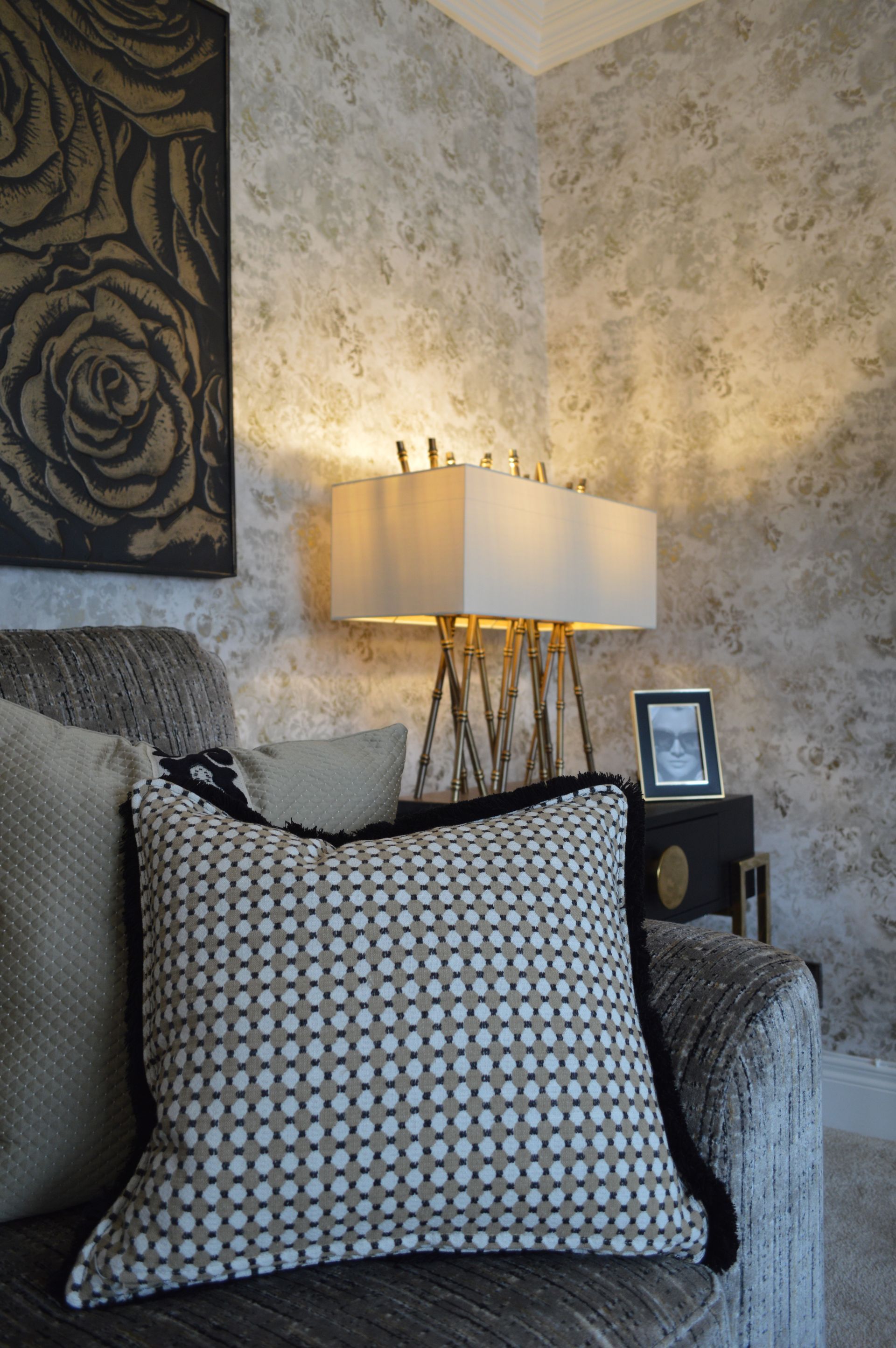 A pillow is sitting on a chair in a living room.