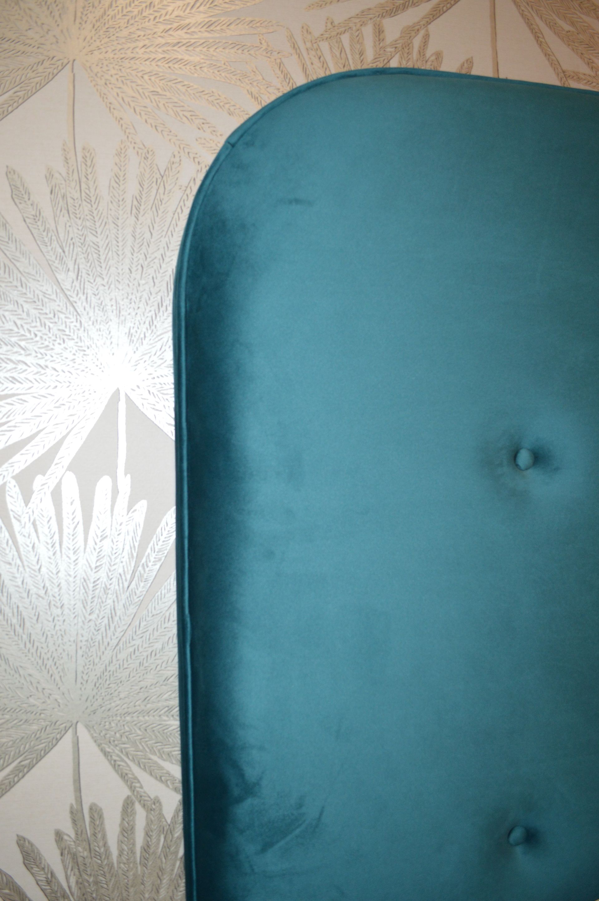 A close up of a blue chair cushion on a wall.