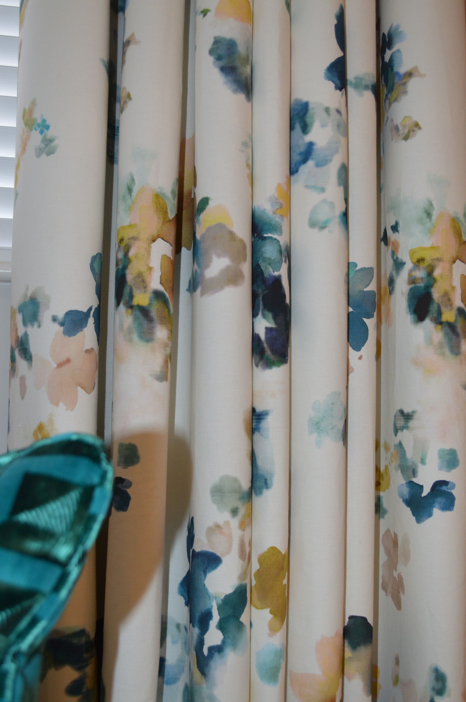 A close up of a pair of curtains with a floral pattern