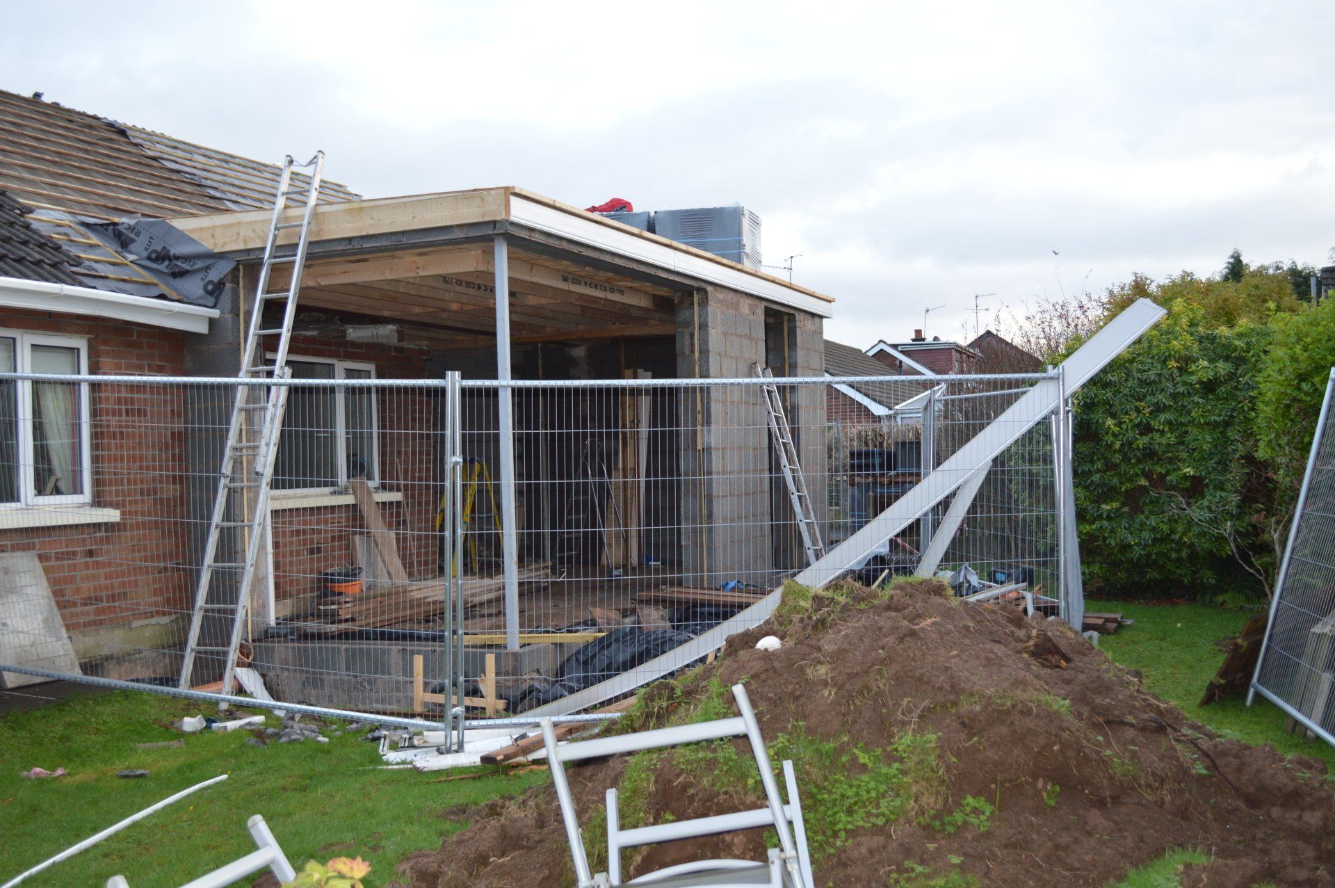A house is being built with a fence around it.