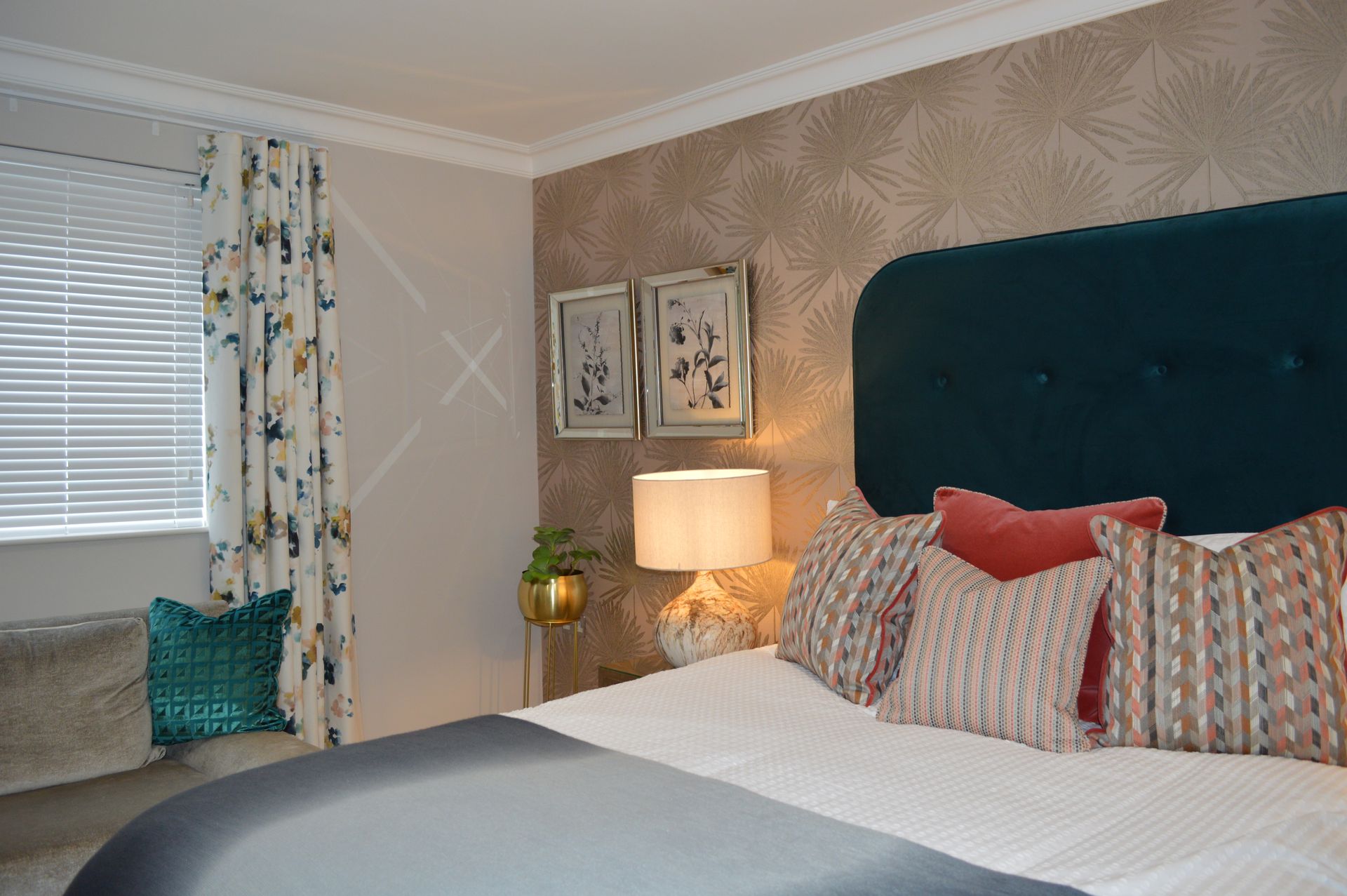 A bedroom with a bed , lamps , curtains and a window.