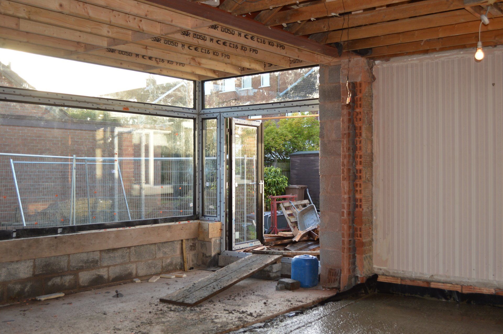 A room with a lot of windows and a concrete floor.